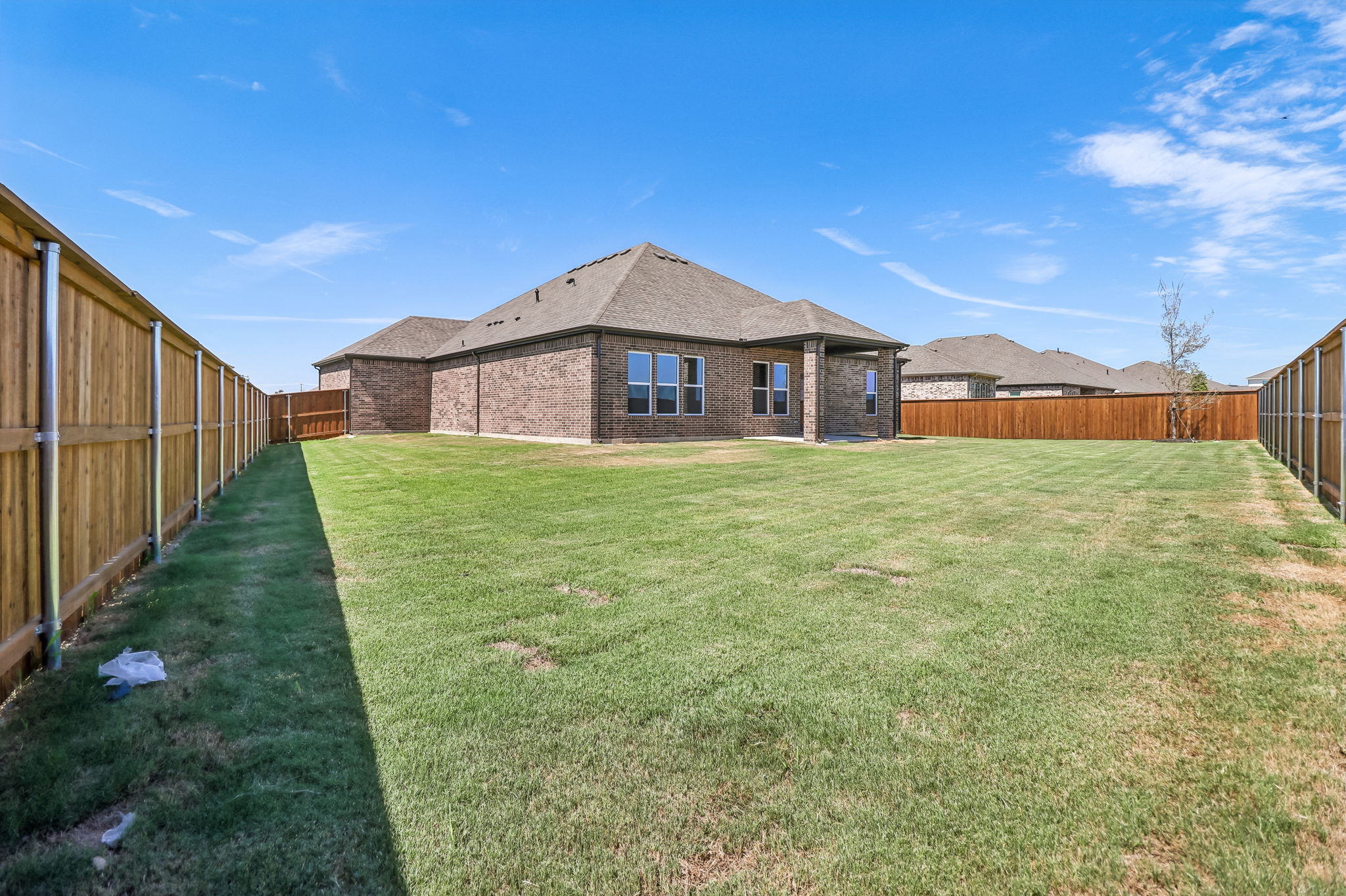 A house with a fence and grass.