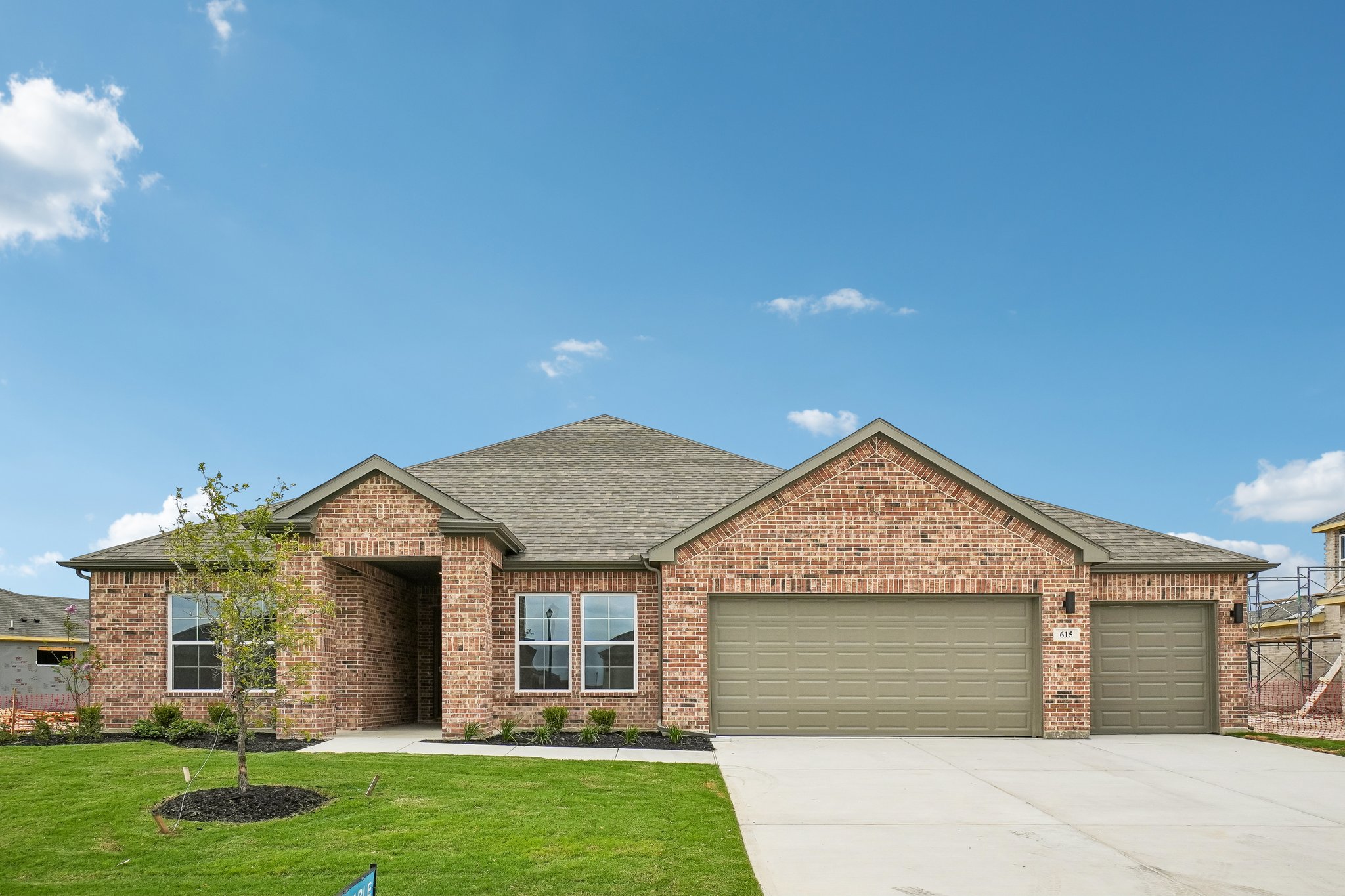 A brick house with a garage.