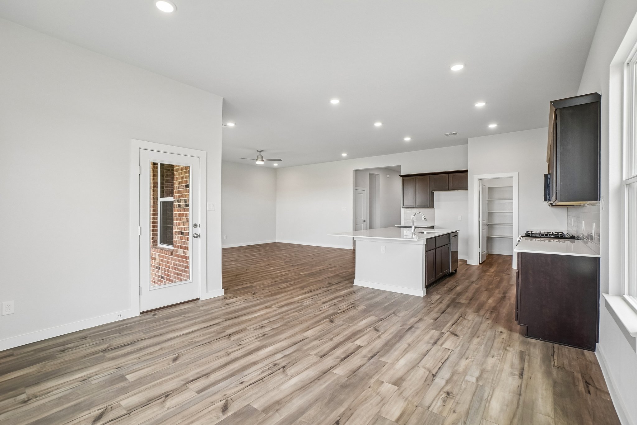A large kitchen with wood floors.