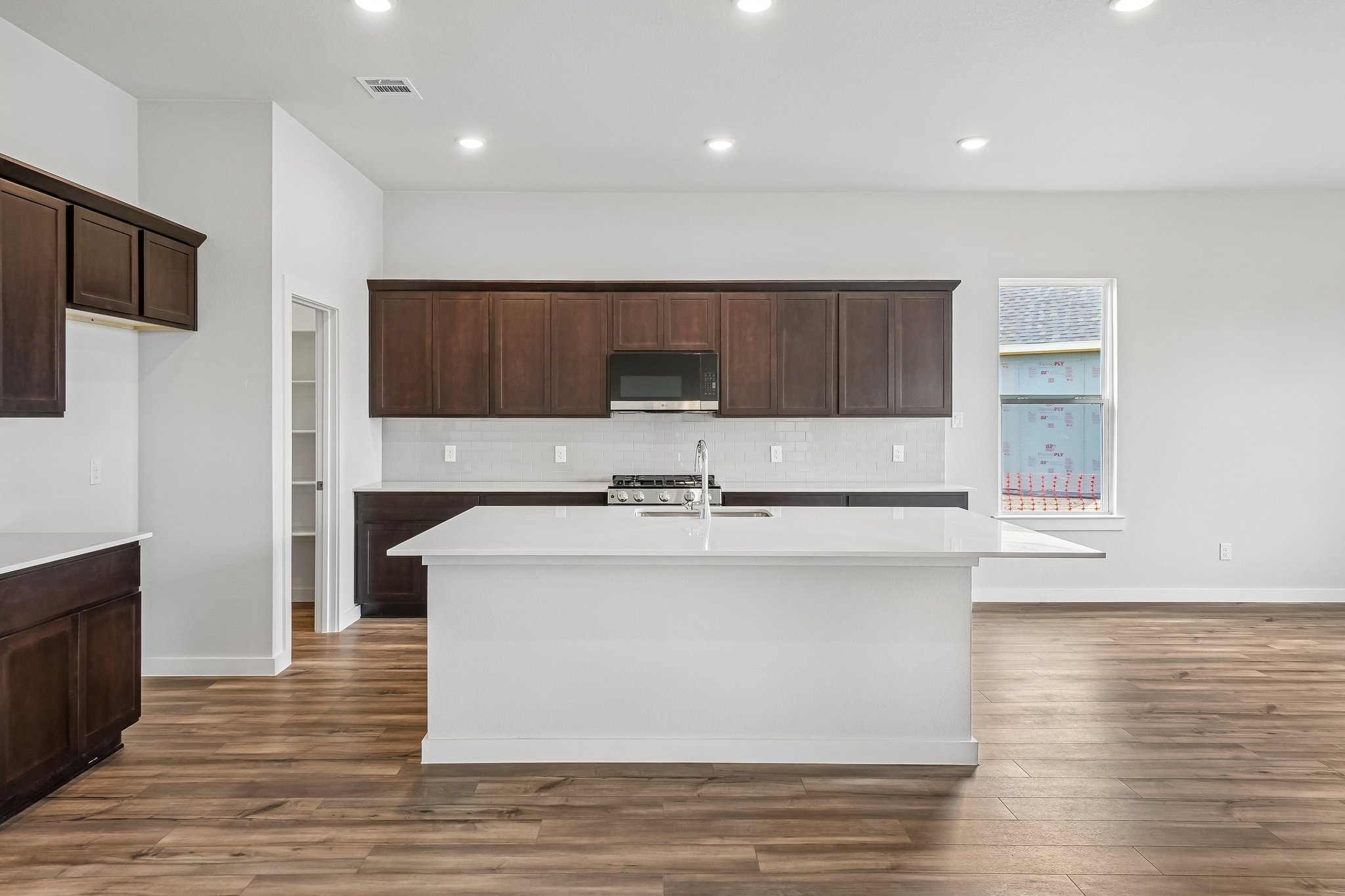 A kitchen with wooden cabinets.