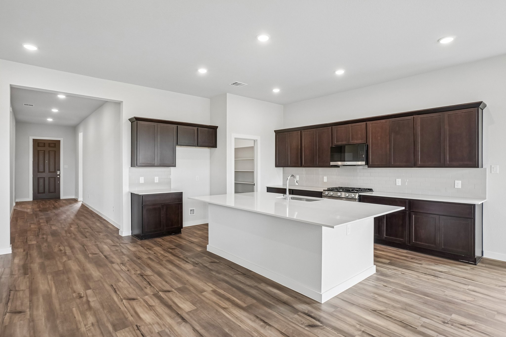 A kitchen with wooden cabinets.