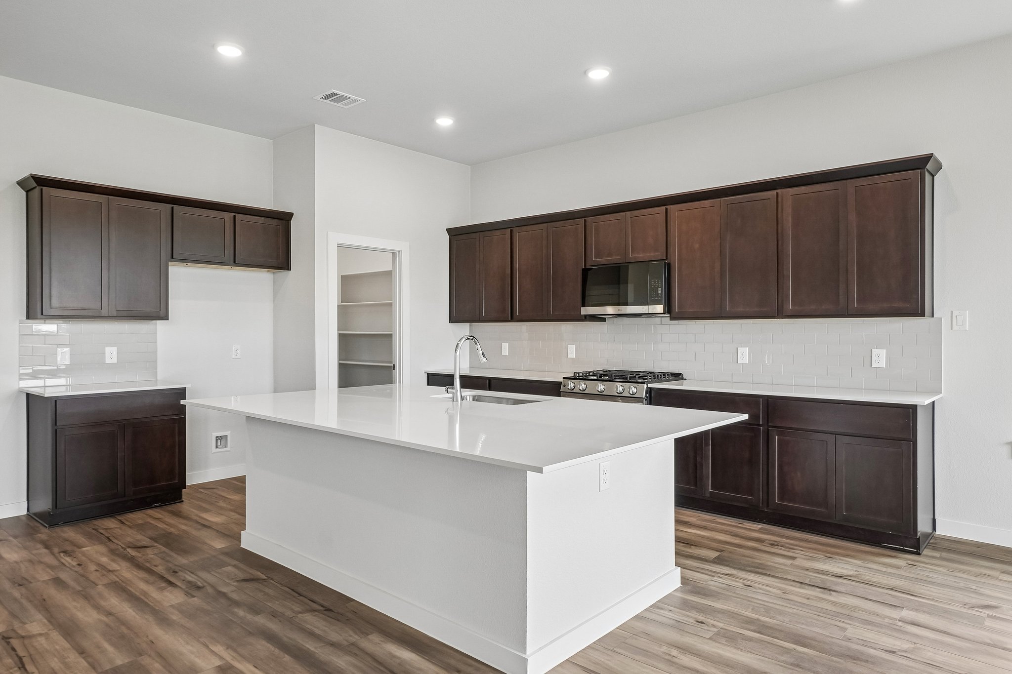A kitchen with wooden cabinets.
