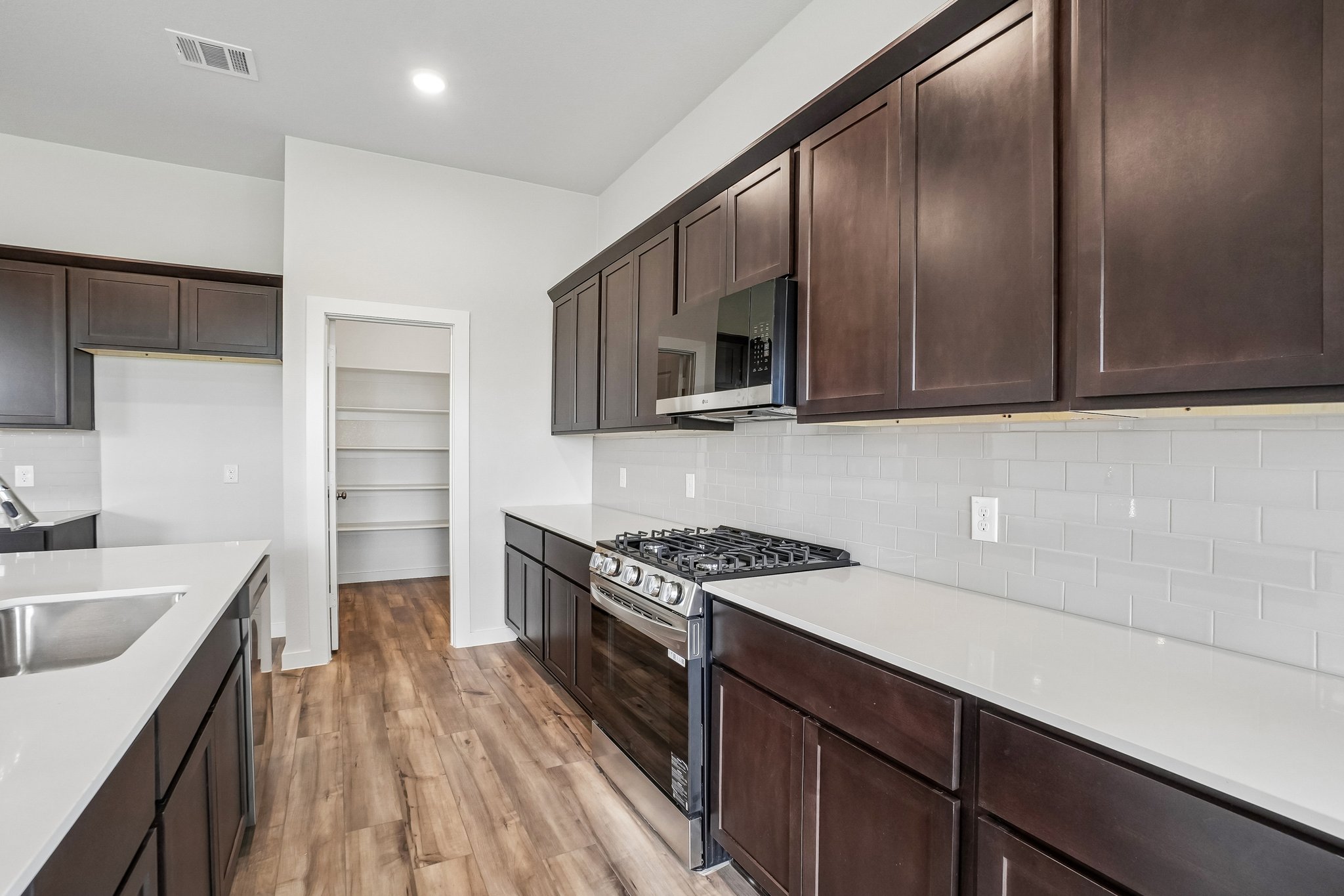 A kitchen with wooden cabinets.