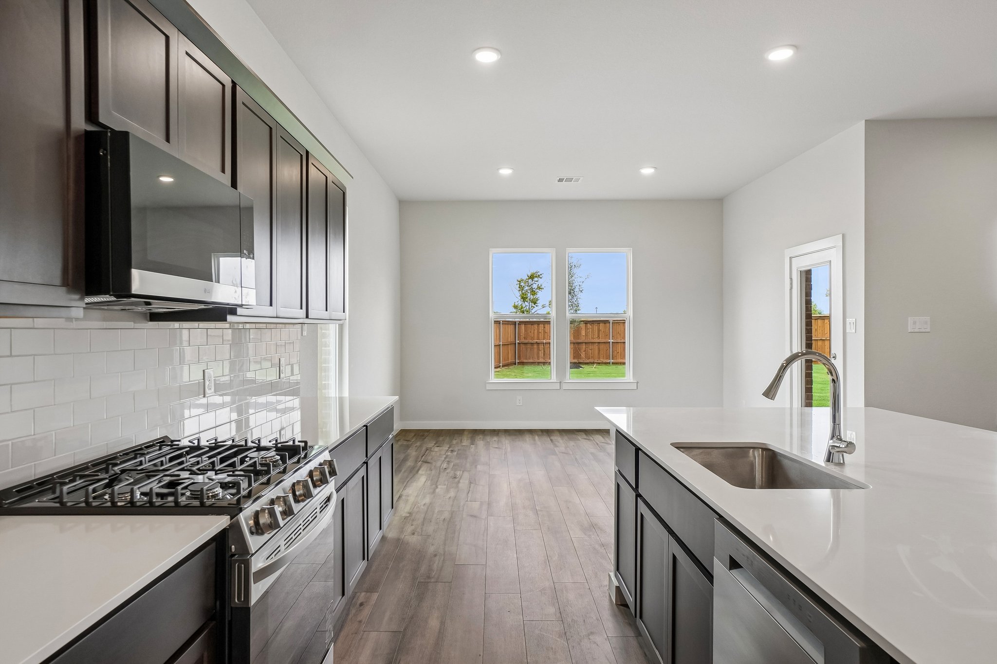 A kitchen with black cabinets.