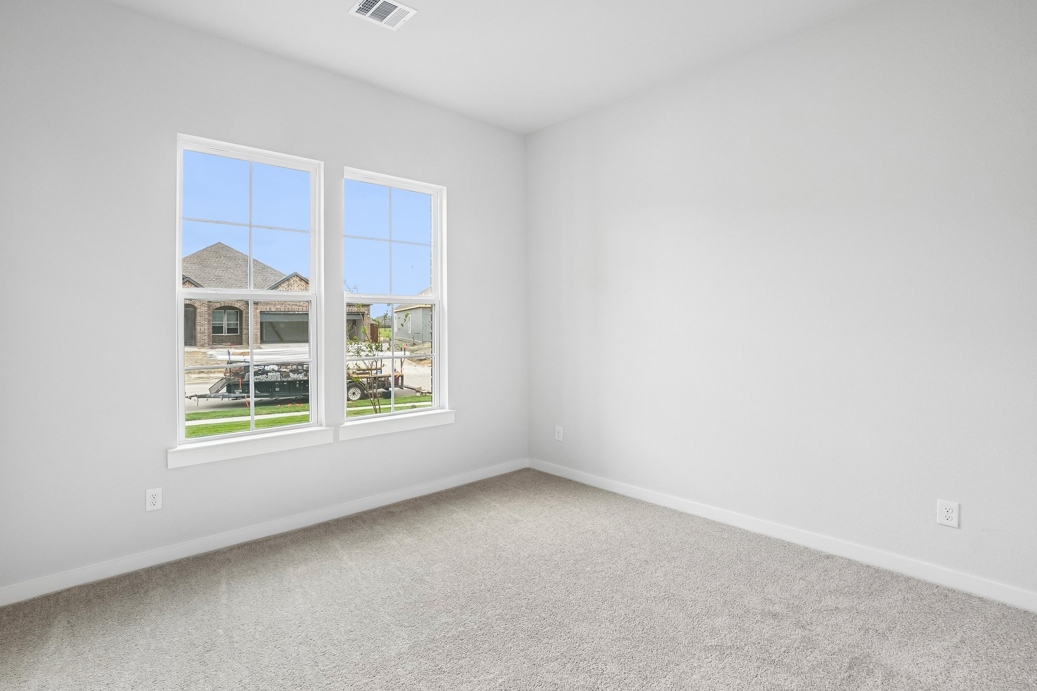 A room with a window and a carpet.