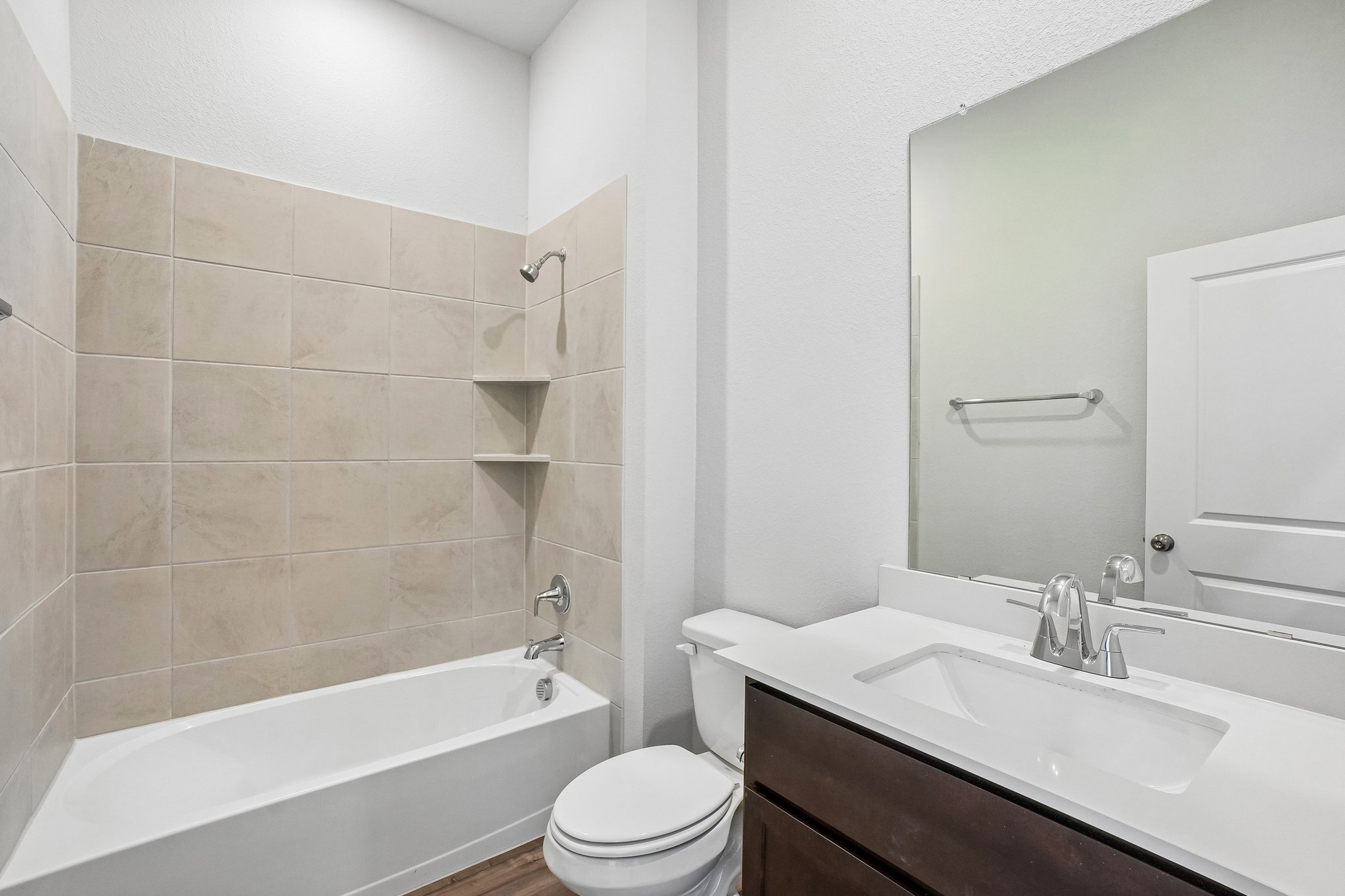 A bathroom with a tub sink and toilet.