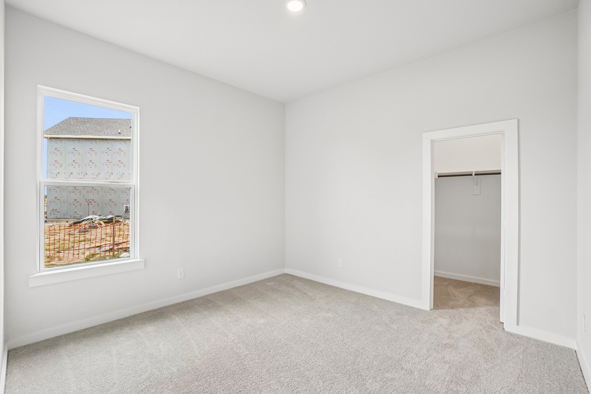 A room with a window and a door.