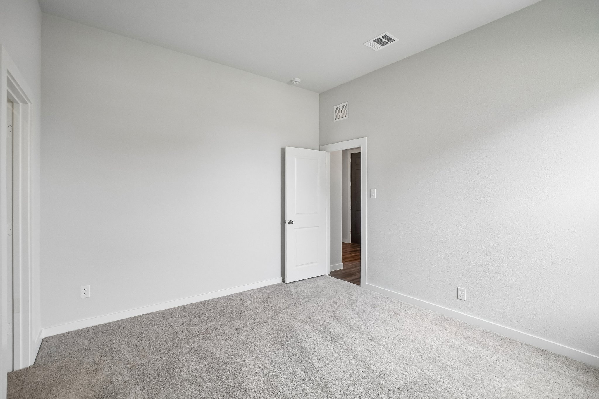 A hallway with white walls.