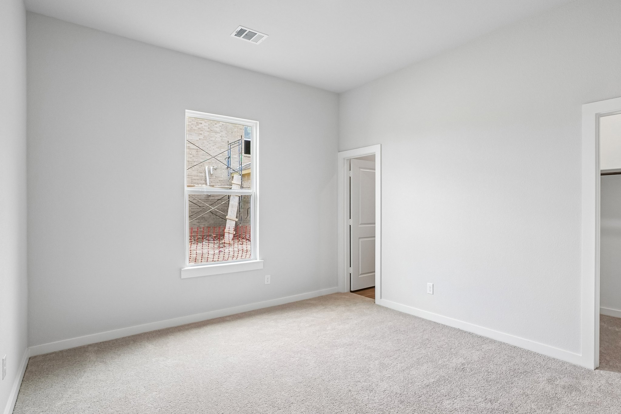 A room with a window and a door.