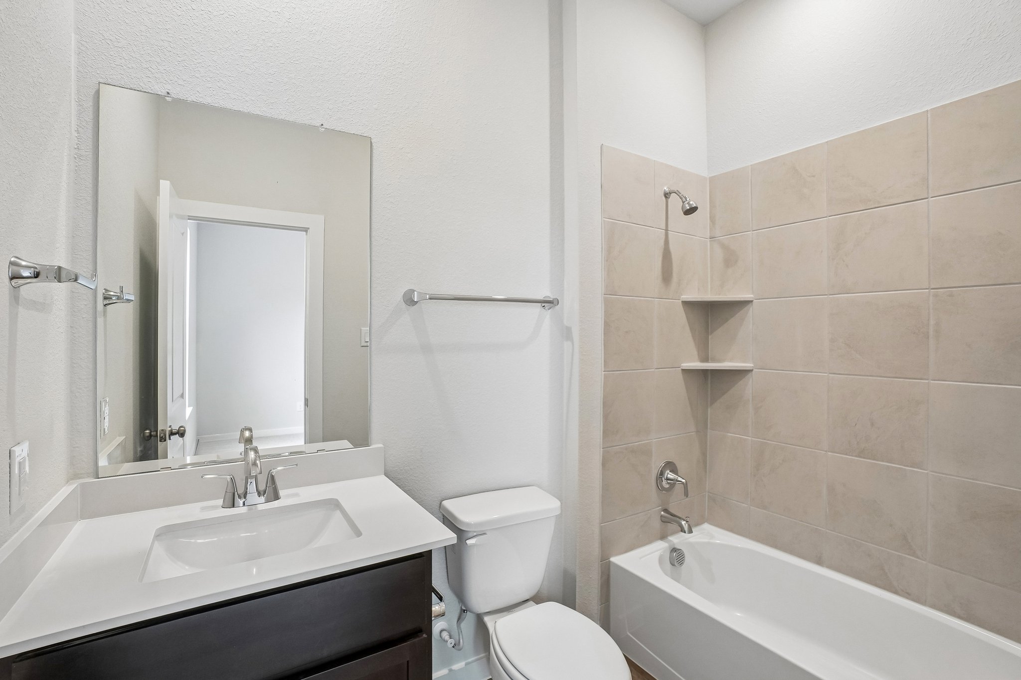 A bathroom with a sink toilet and bathtub.