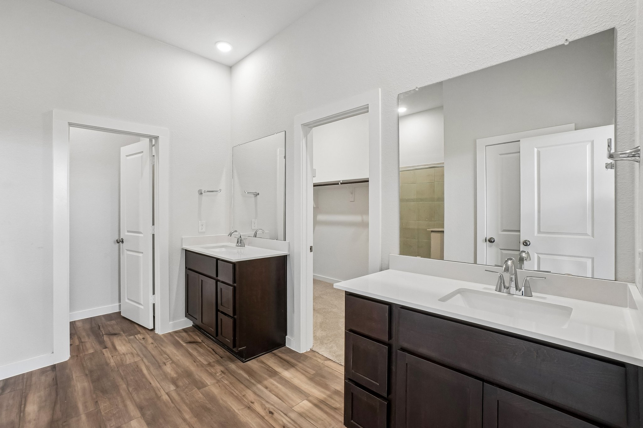 A bathroom with a large mirror.