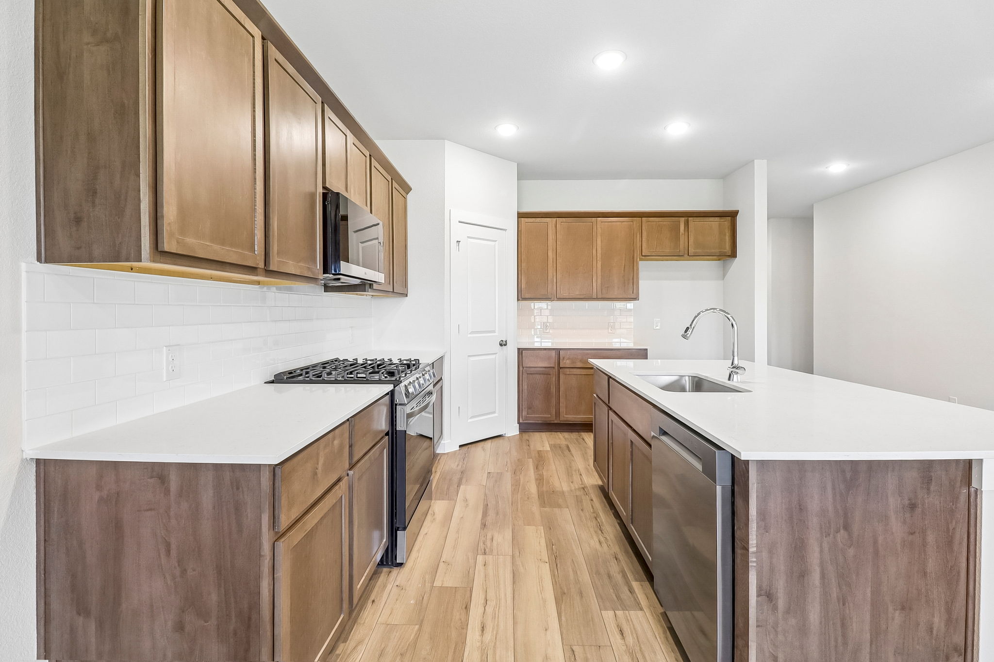 A kitchen with wooden cabinets.