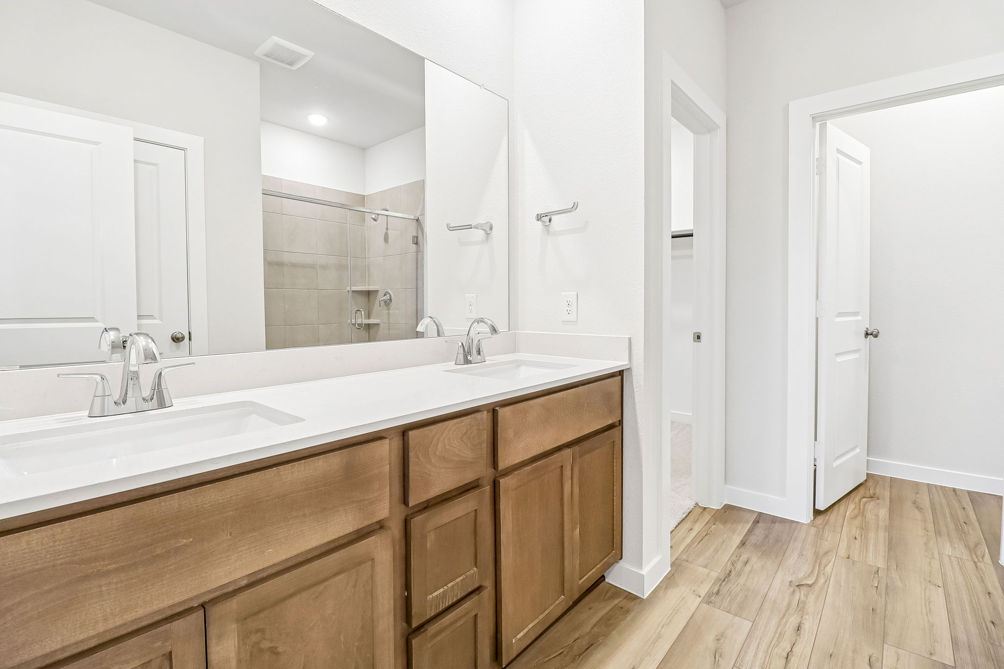 A bathroom with a large mirror.