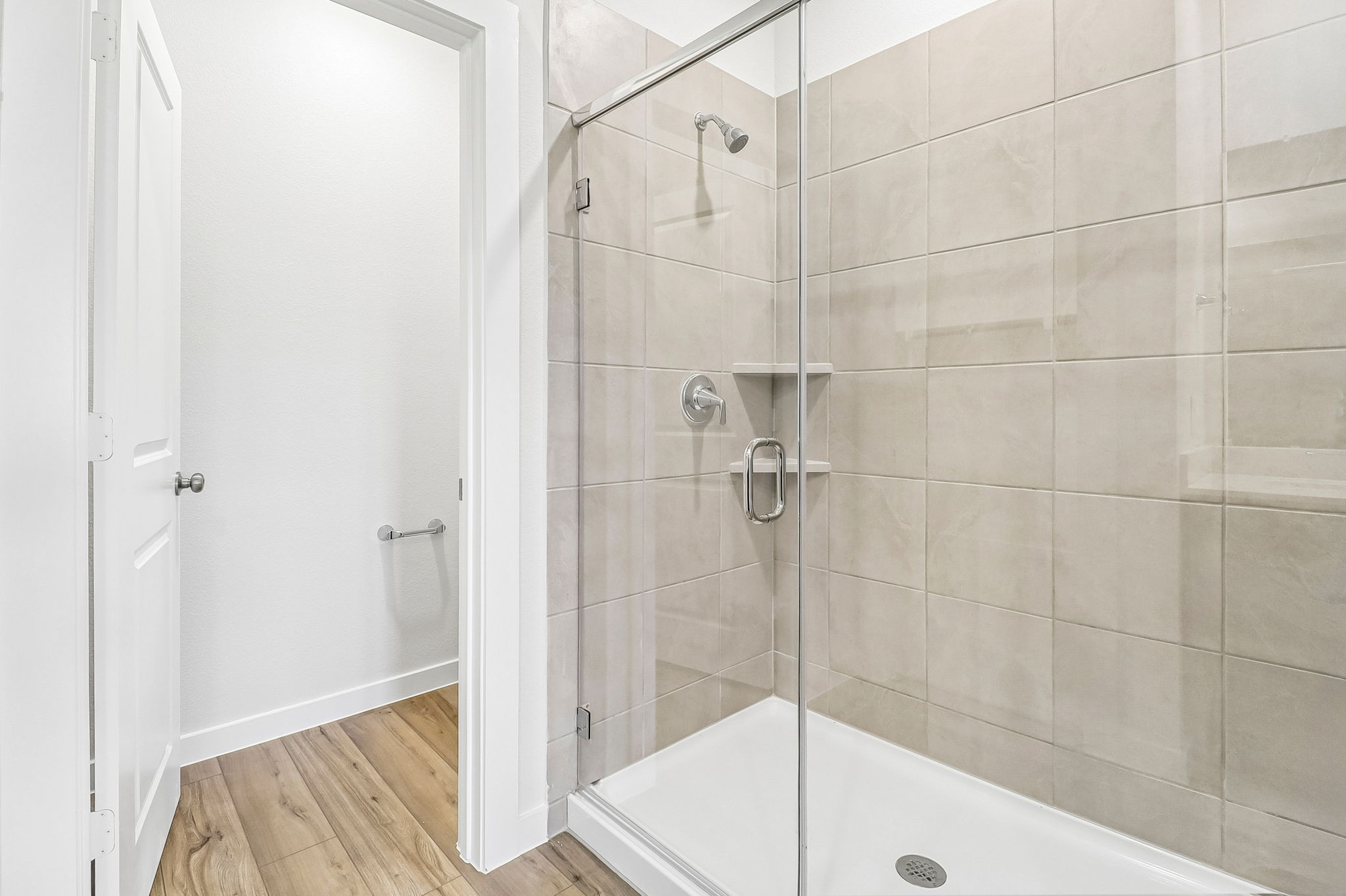 A shower with a glass door.