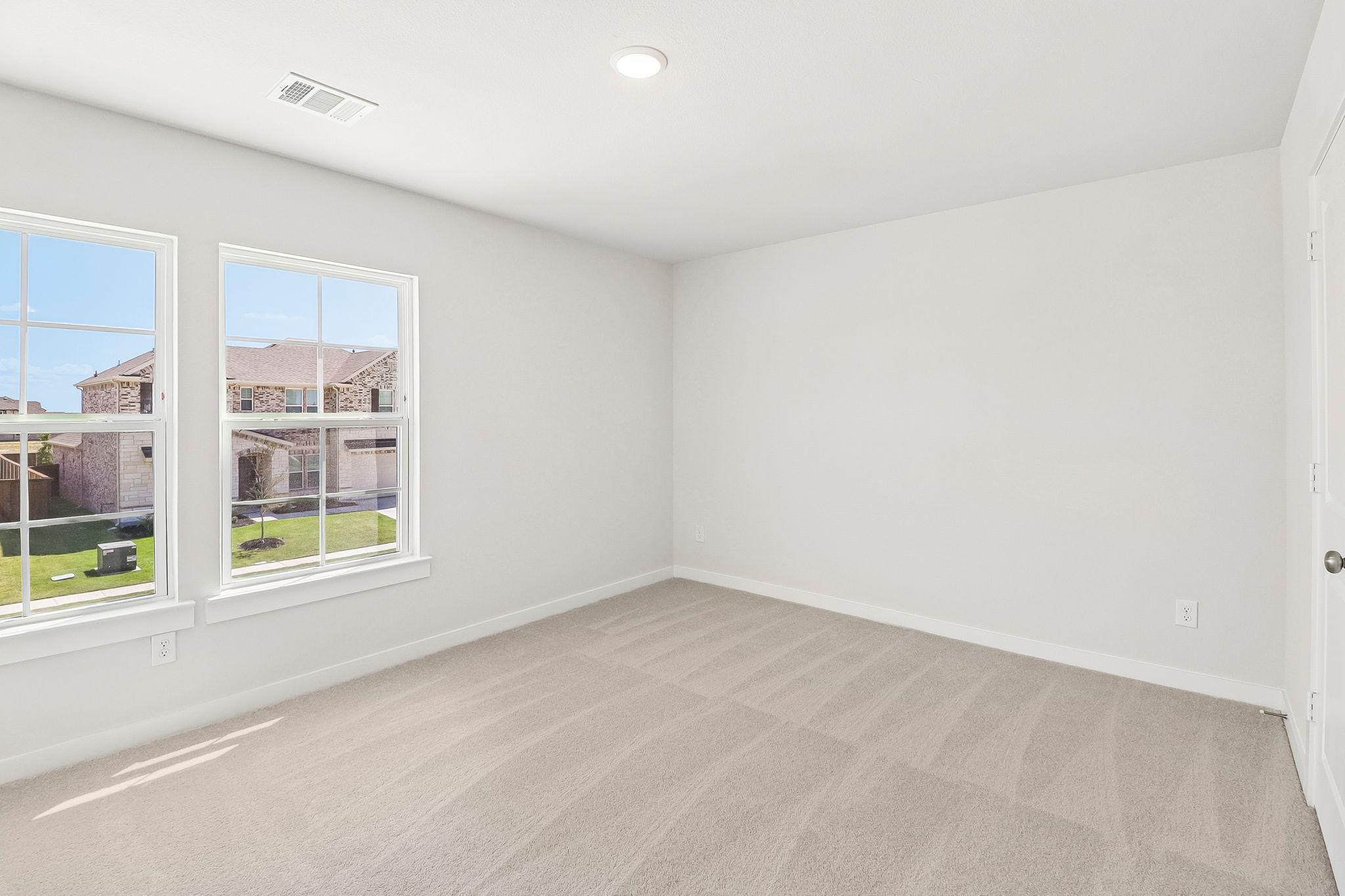 A room with a window and a carpet.