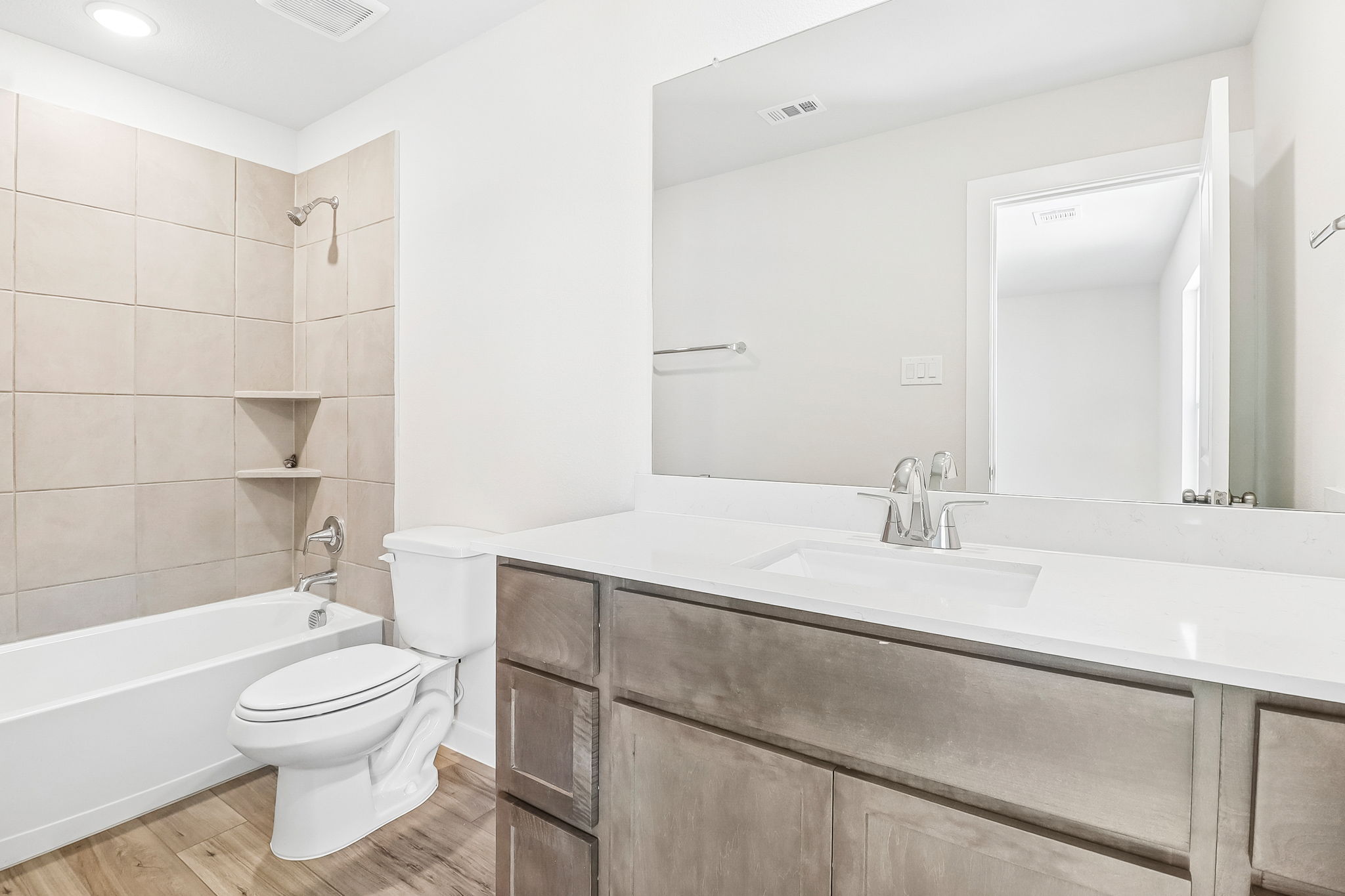A bathroom with a tub toilet and sink.