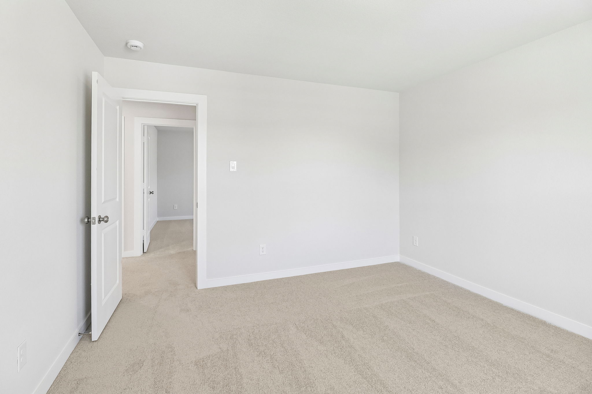 A hallway with white walls.