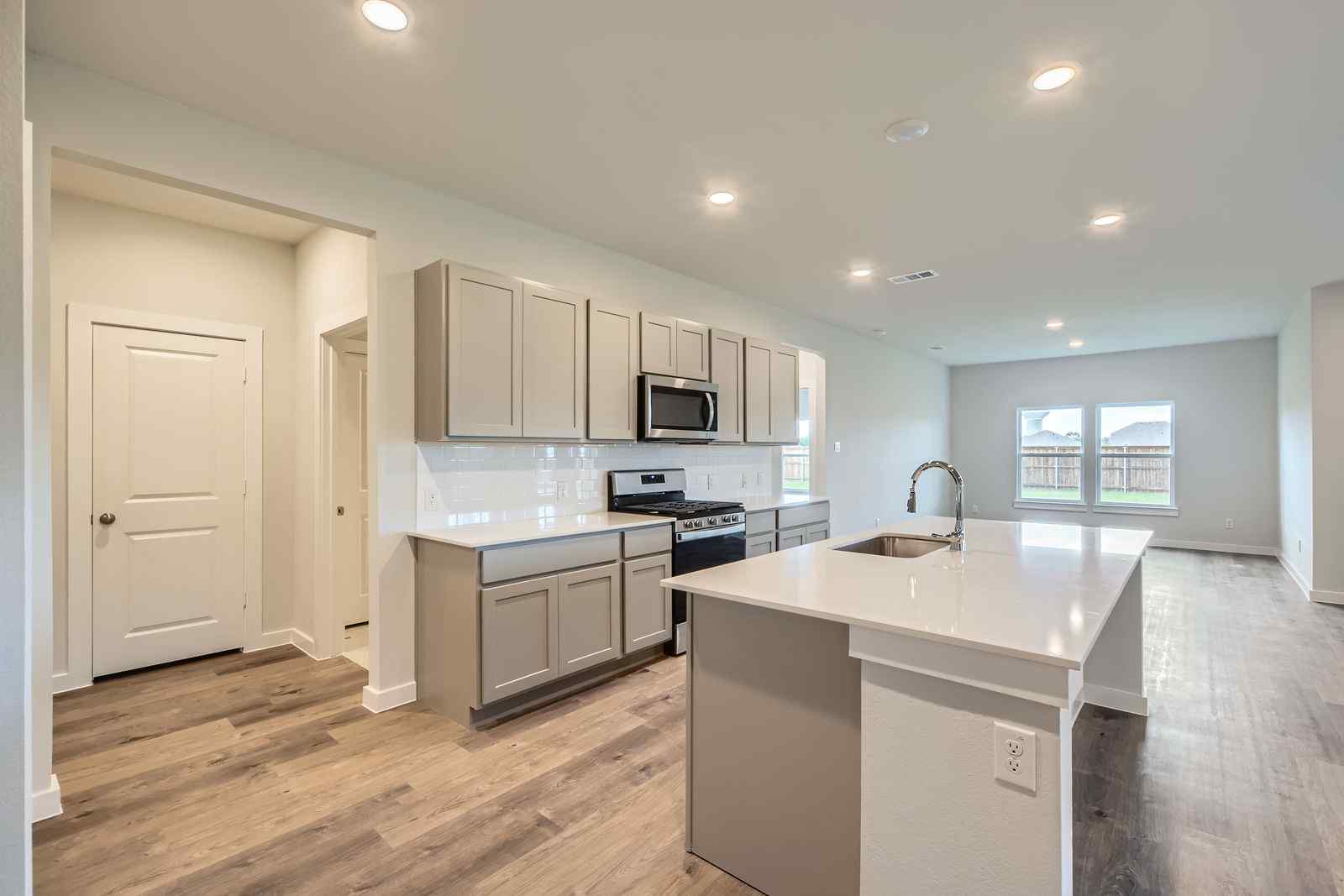 A kitchen with white cabinets.