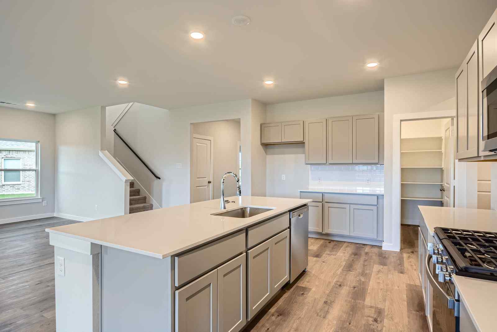A kitchen with white cabinets.