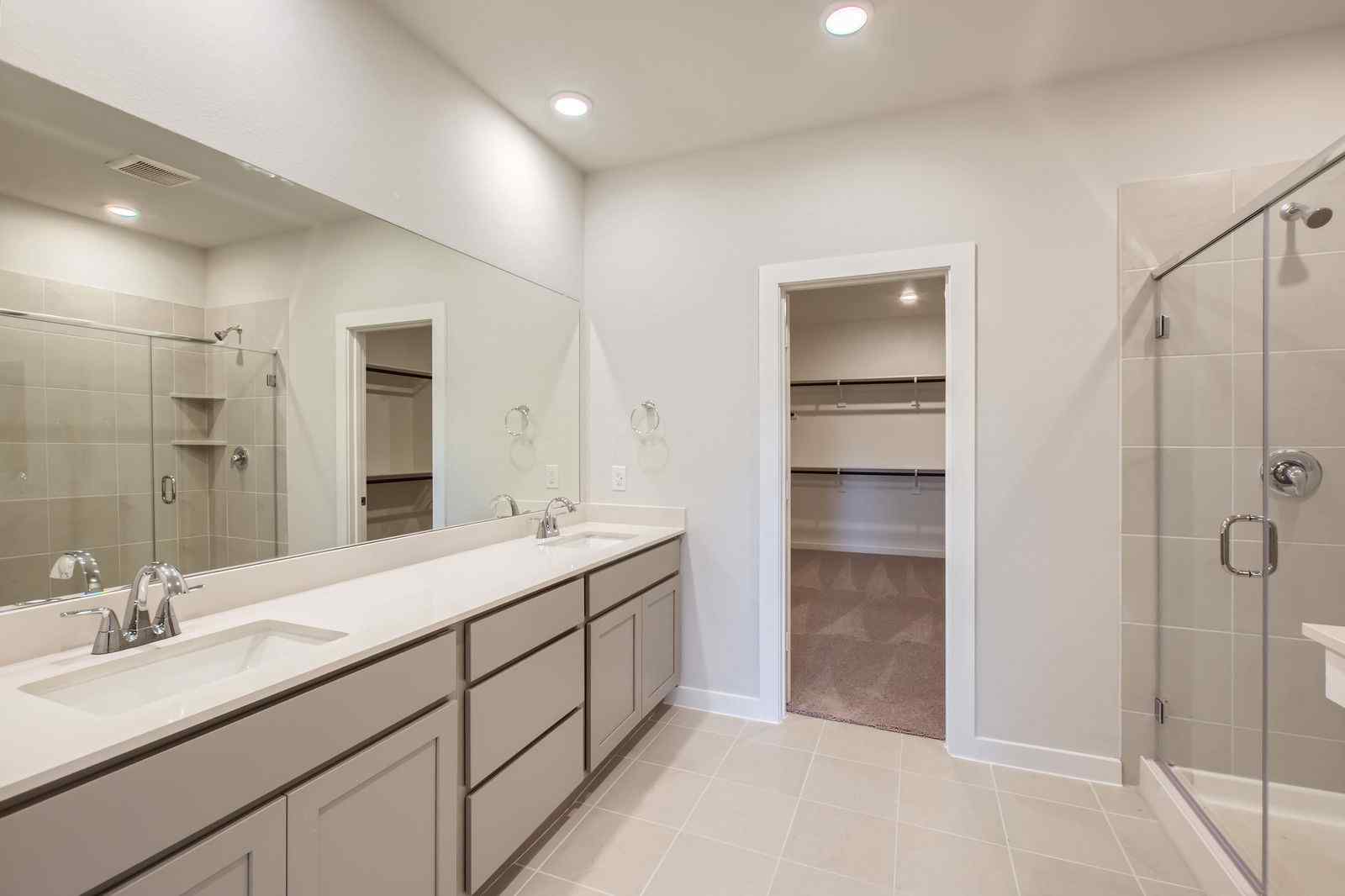 A bathroom with a shower and sink.