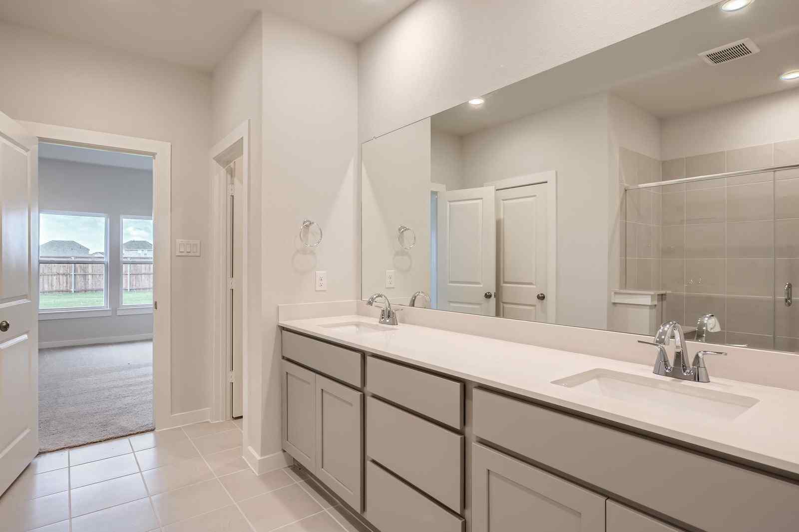 A bathroom with a large mirror.