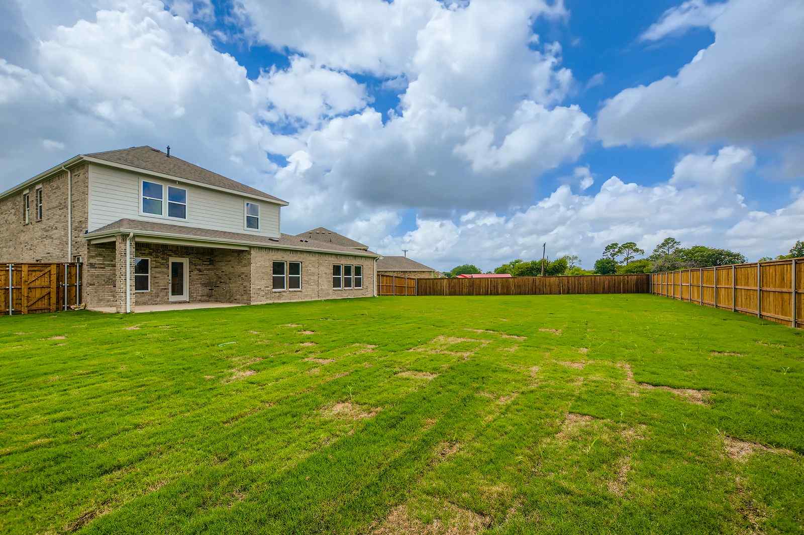 A house with a fence and grass.