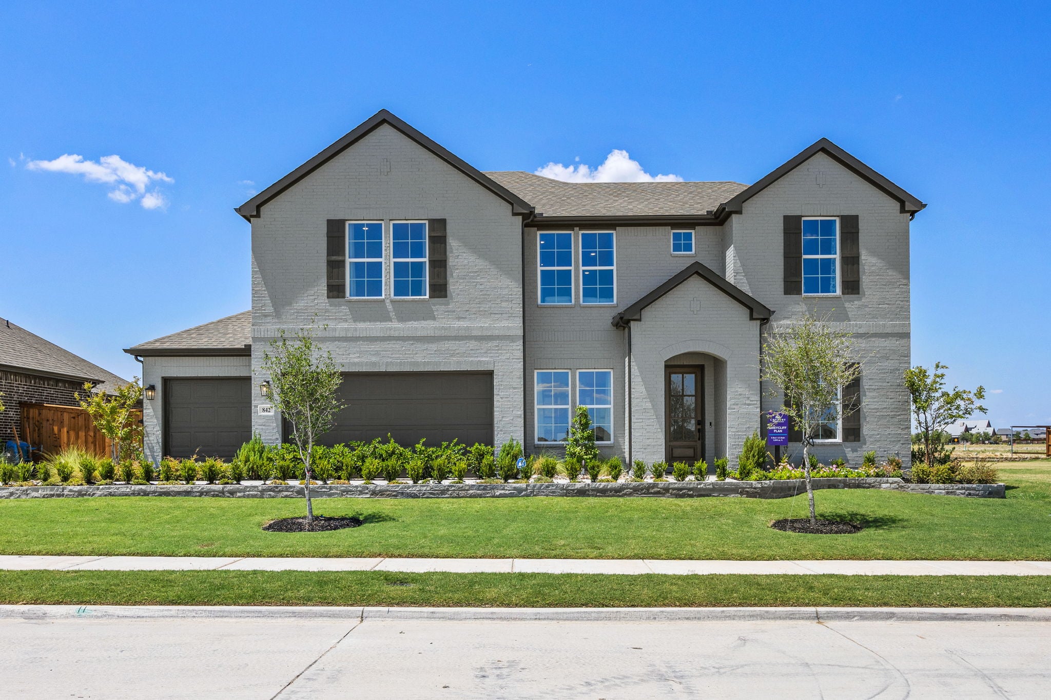 A house with a lawn and trees.