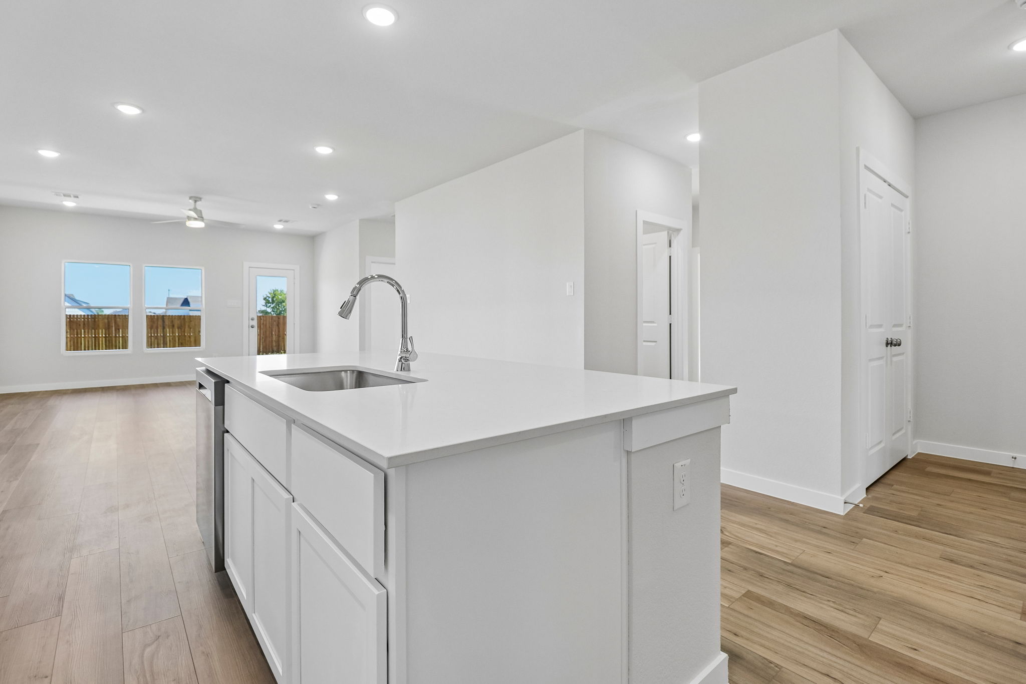 A kitchen with white cabinets.