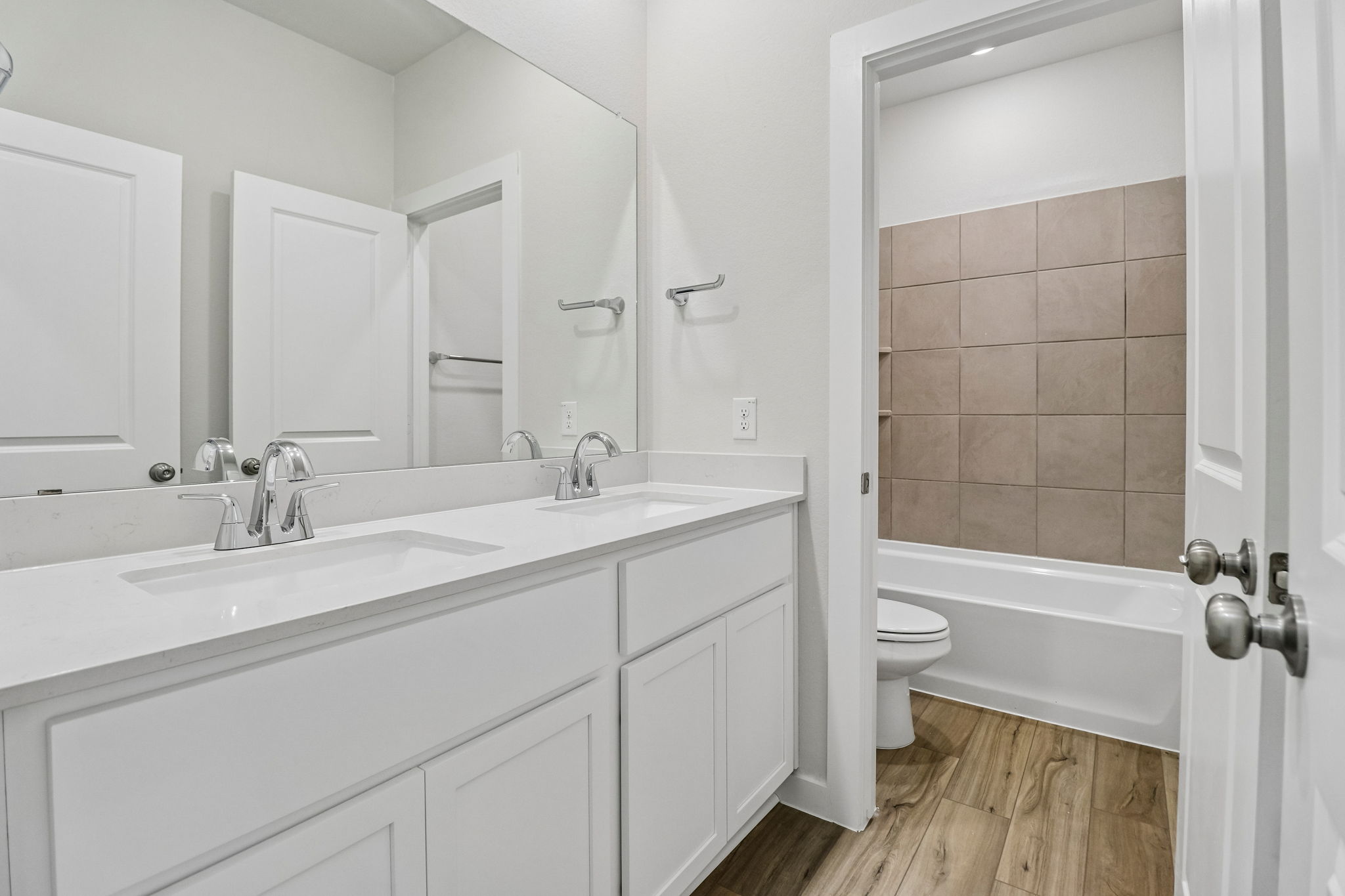A bathroom with a tub sink and toilet.