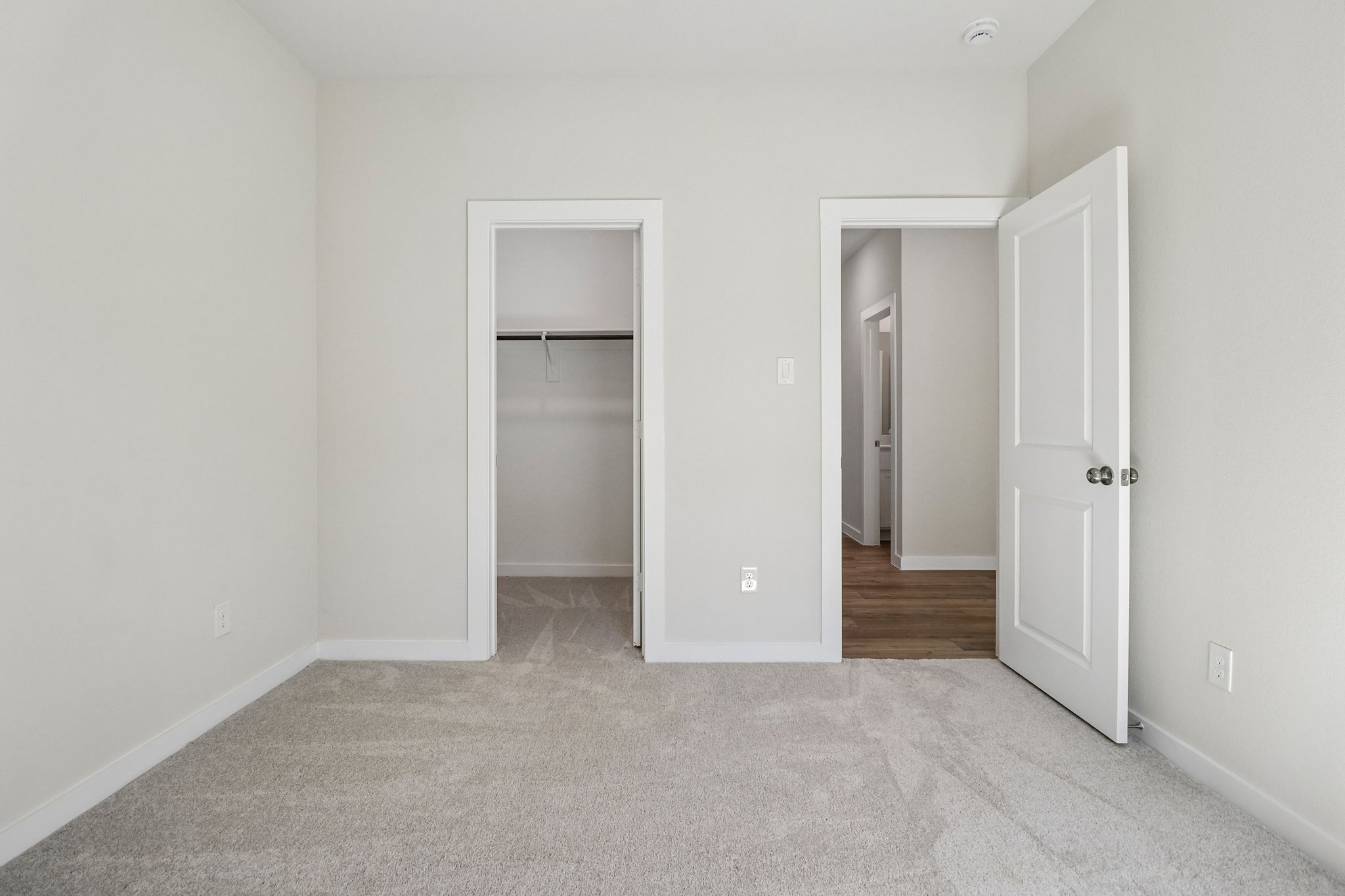 A hallway with white walls.