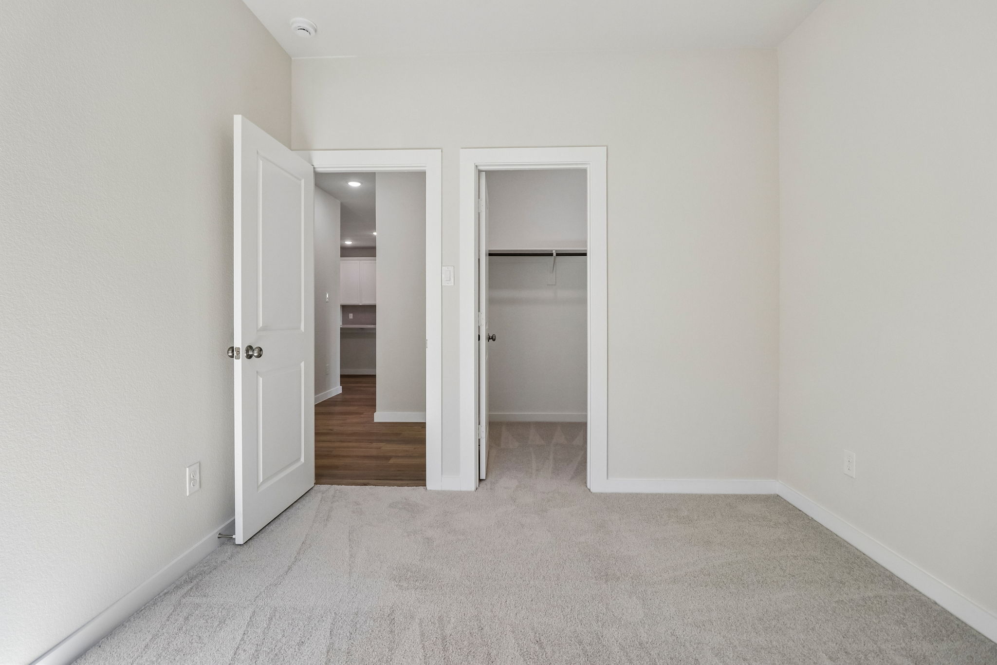 A hallway with white doors.