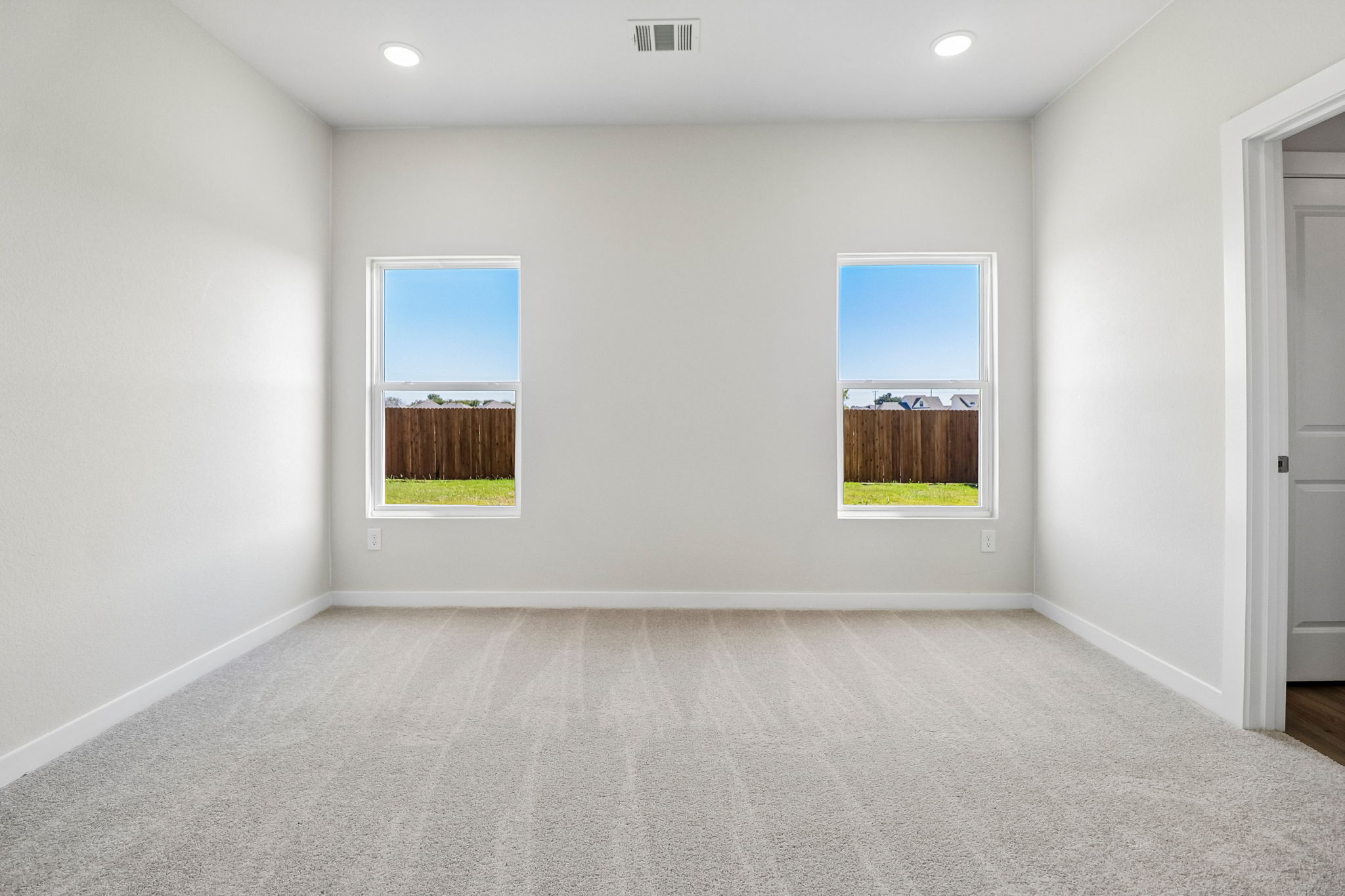 A room with a window and a door.