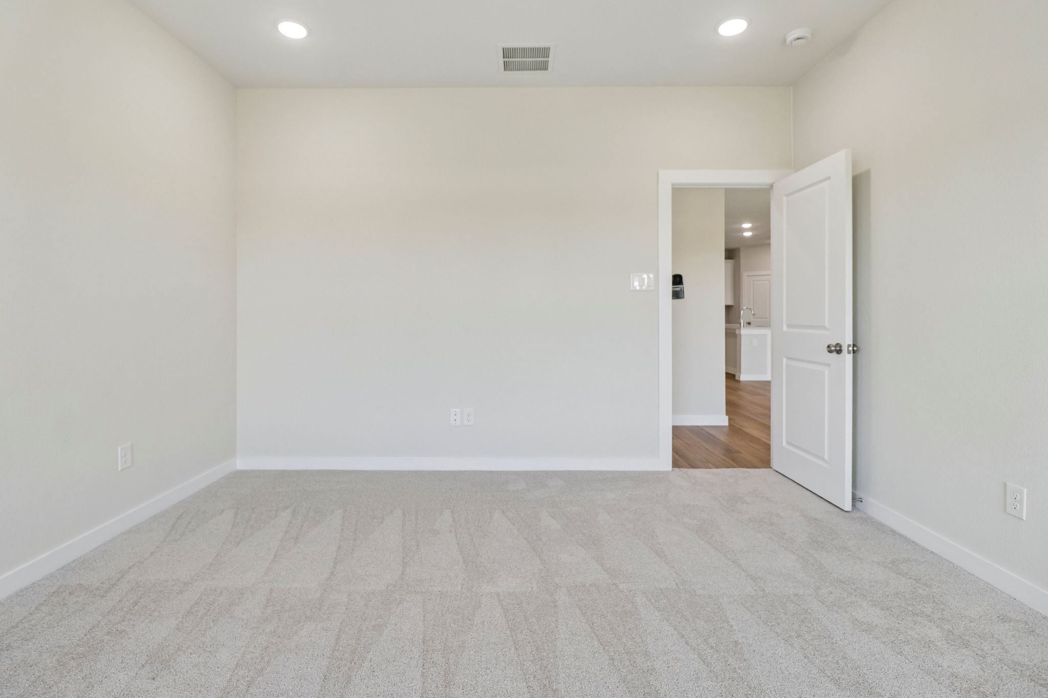 A hallway with white walls.