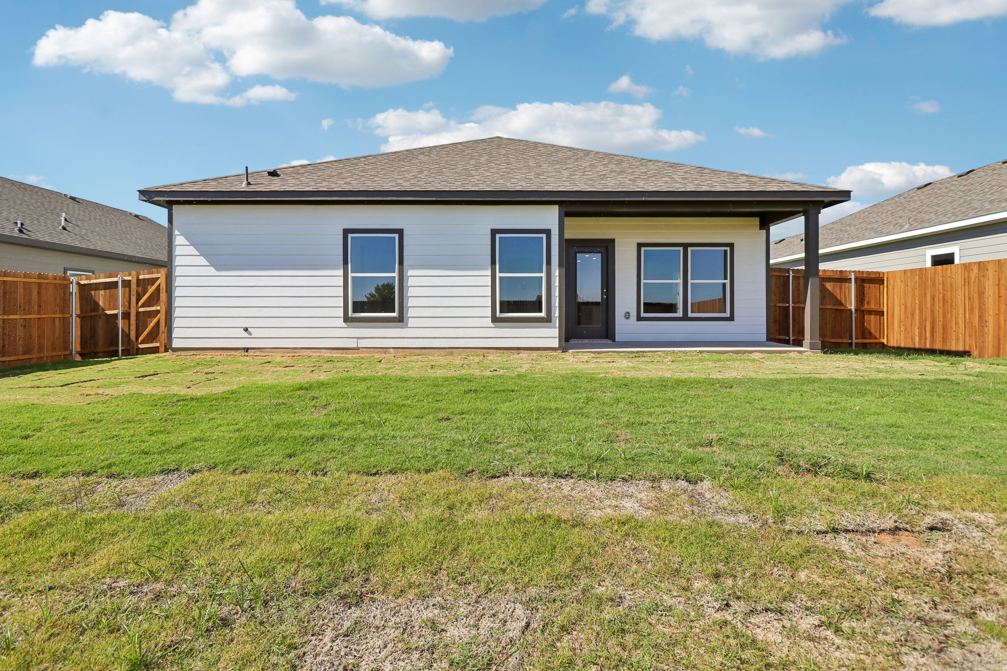 A house with a grass yard.