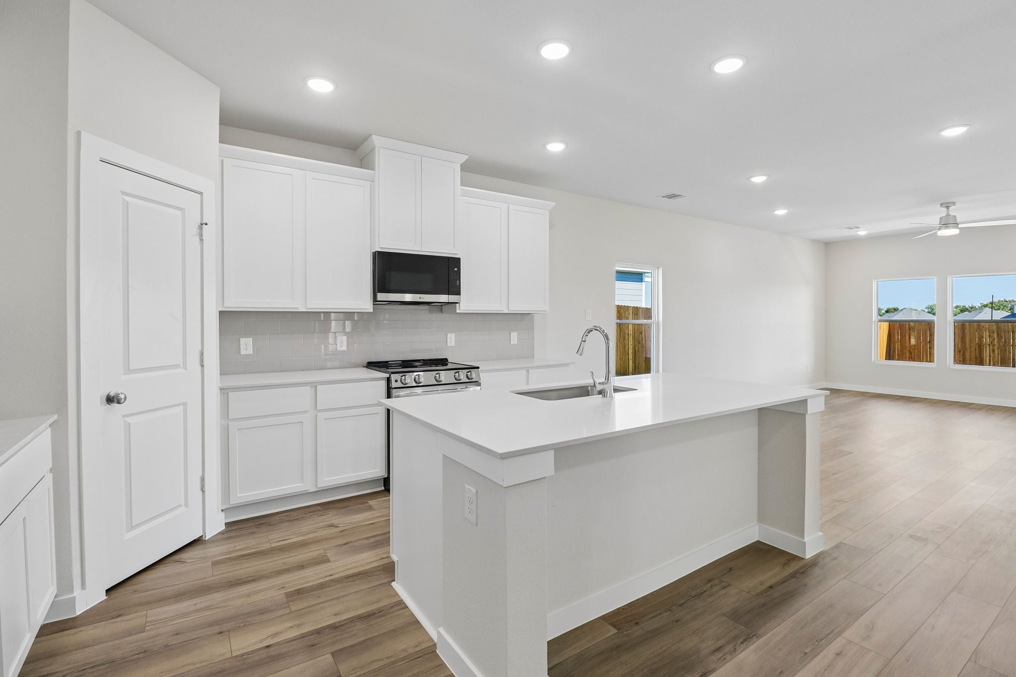 A kitchen with white cabinets.