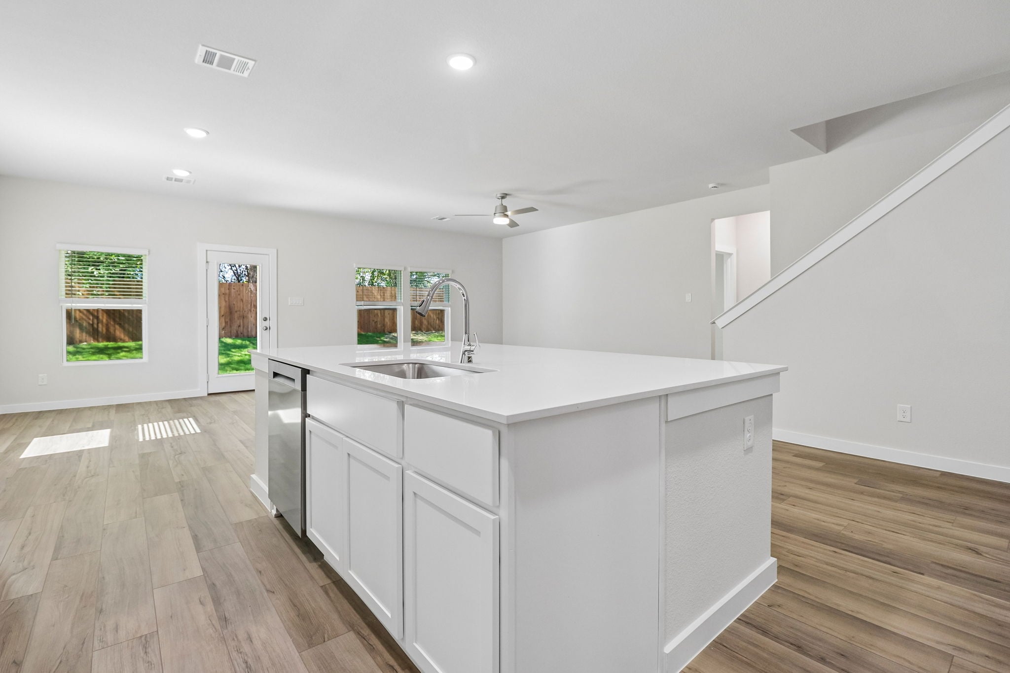 A kitchen with white cabinets.