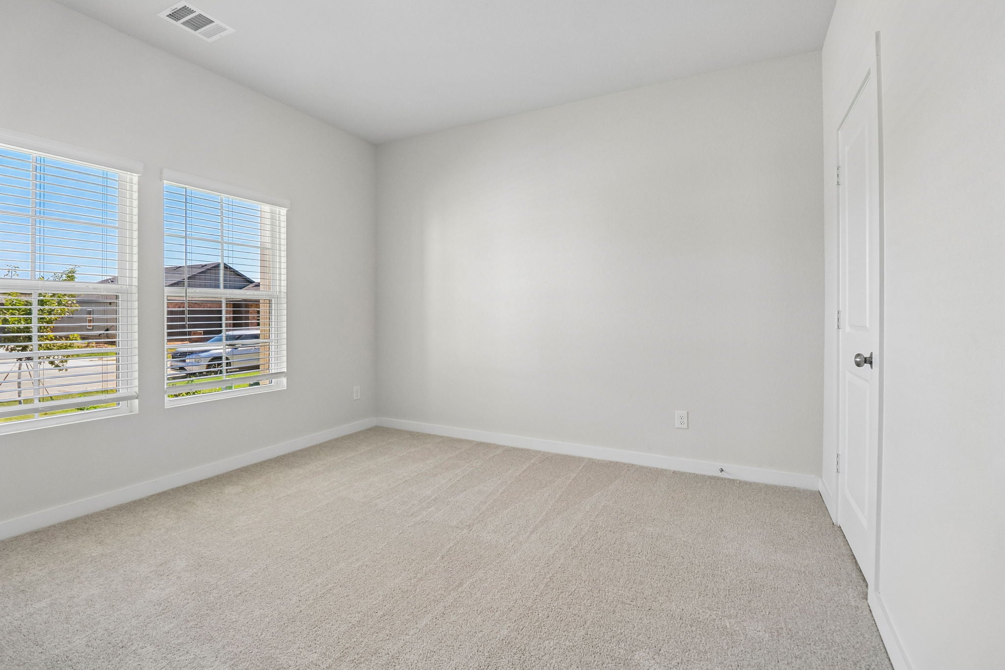 A room with a window and a door.