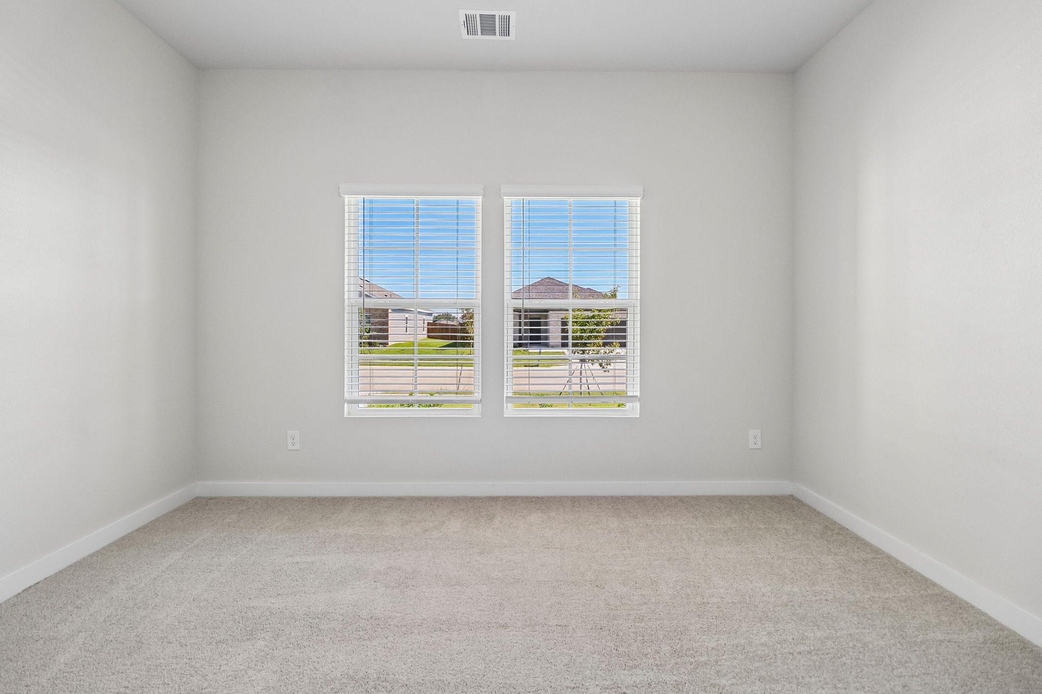 A room with a window and a carpet.