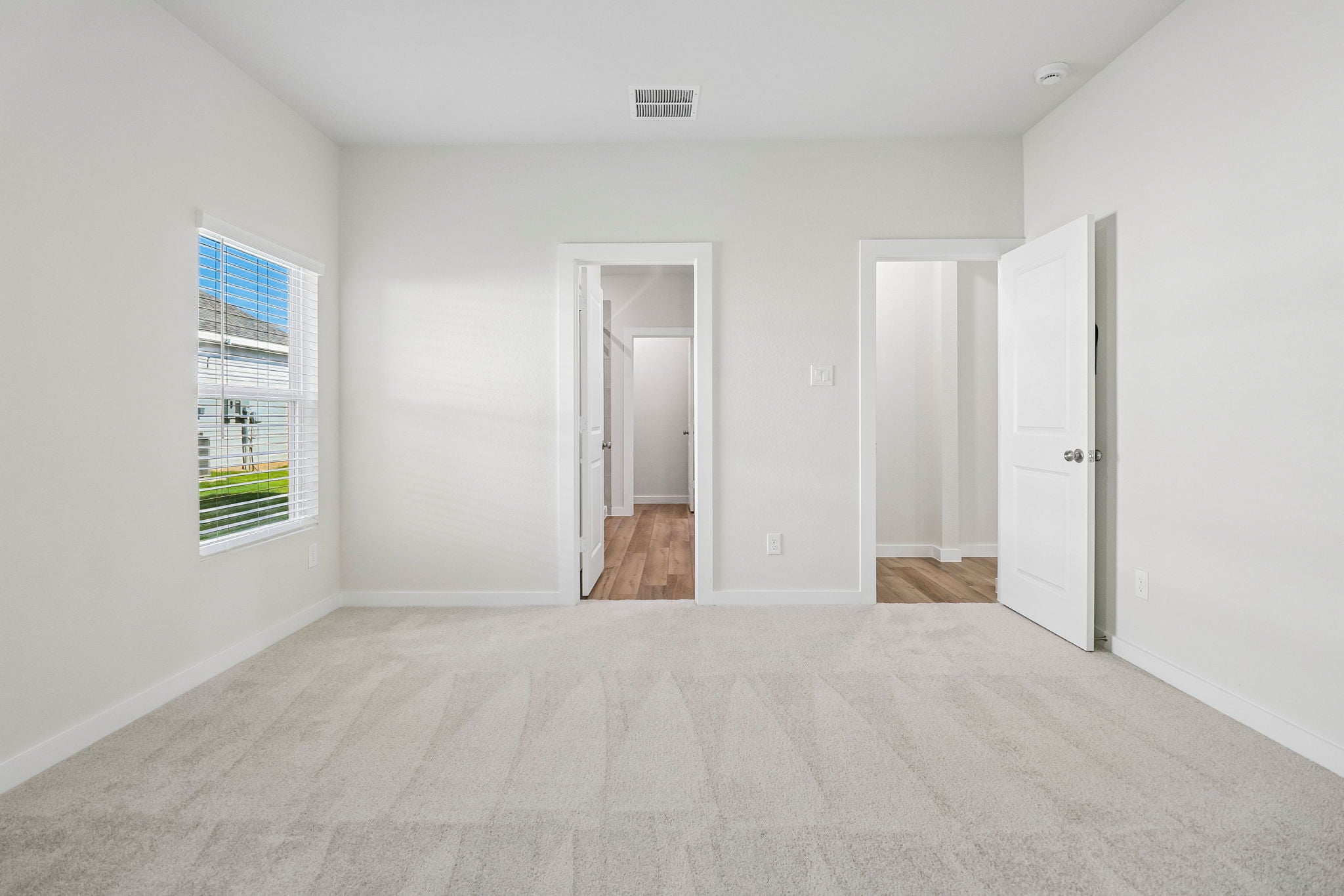 A hallway with white walls.
