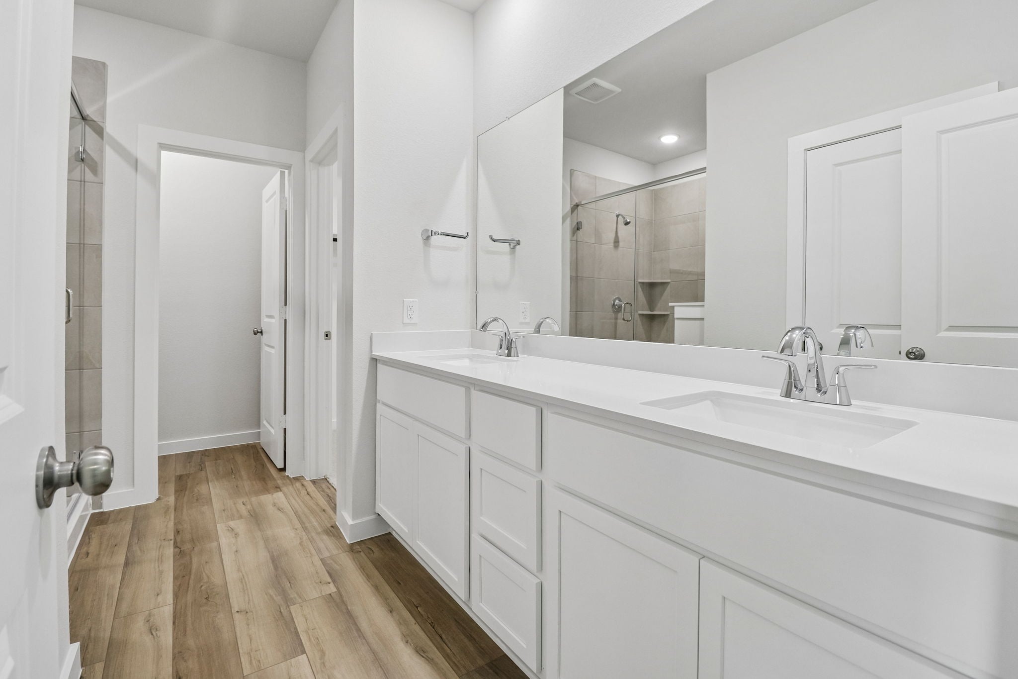 A bathroom with white cabinets.