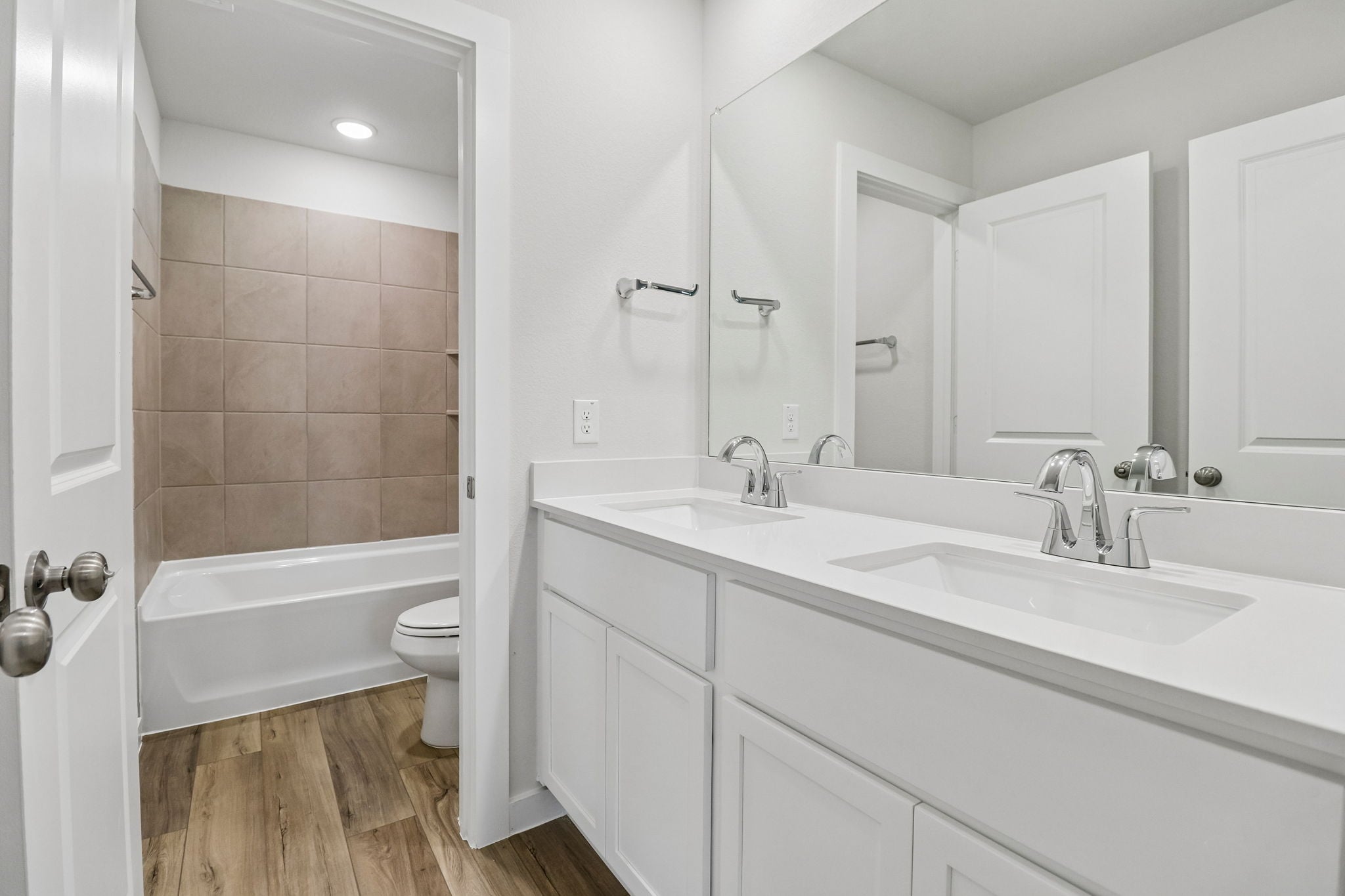 A bathroom with a tub sink and toilet.