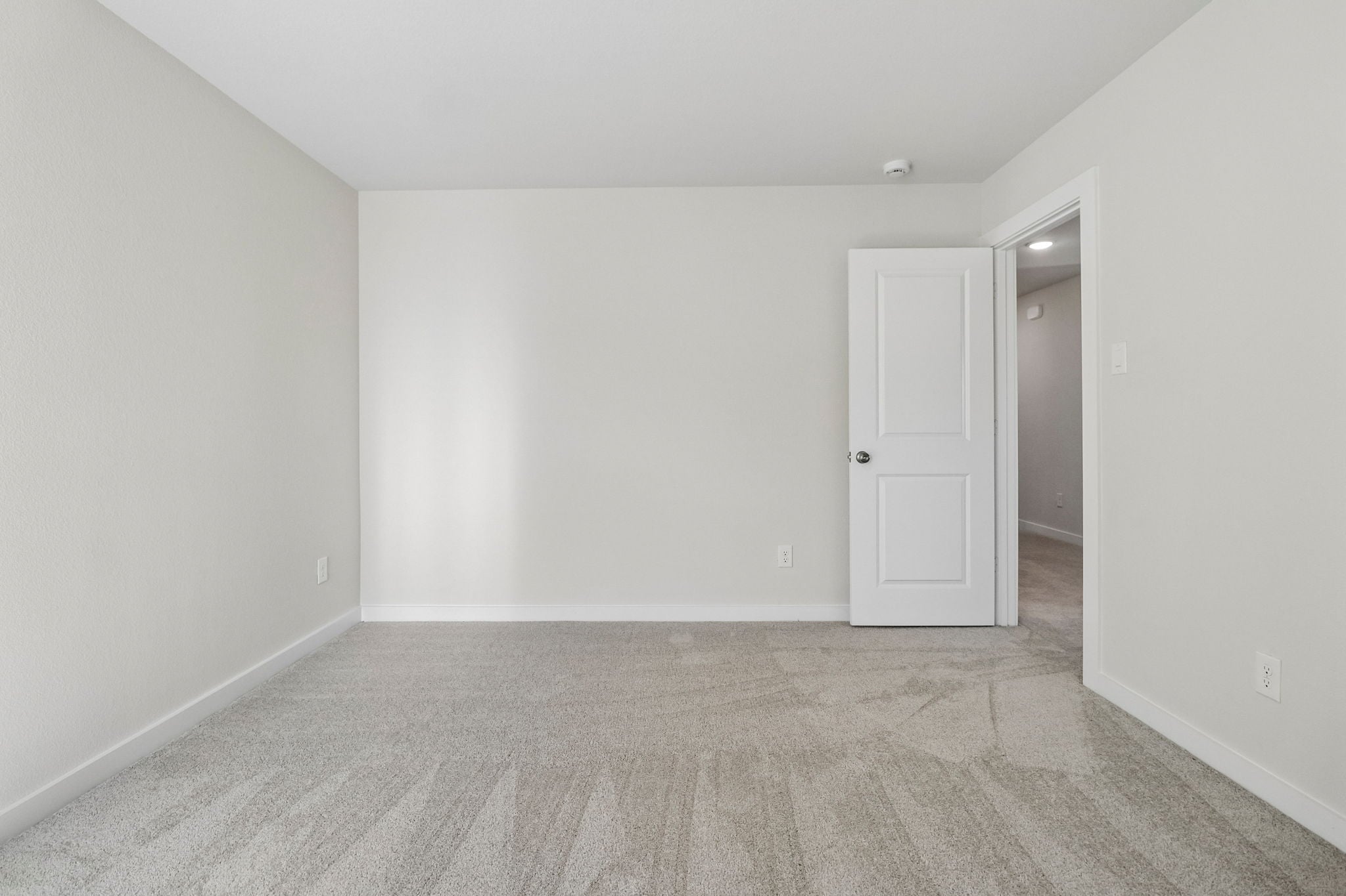 A hallway with white walls.