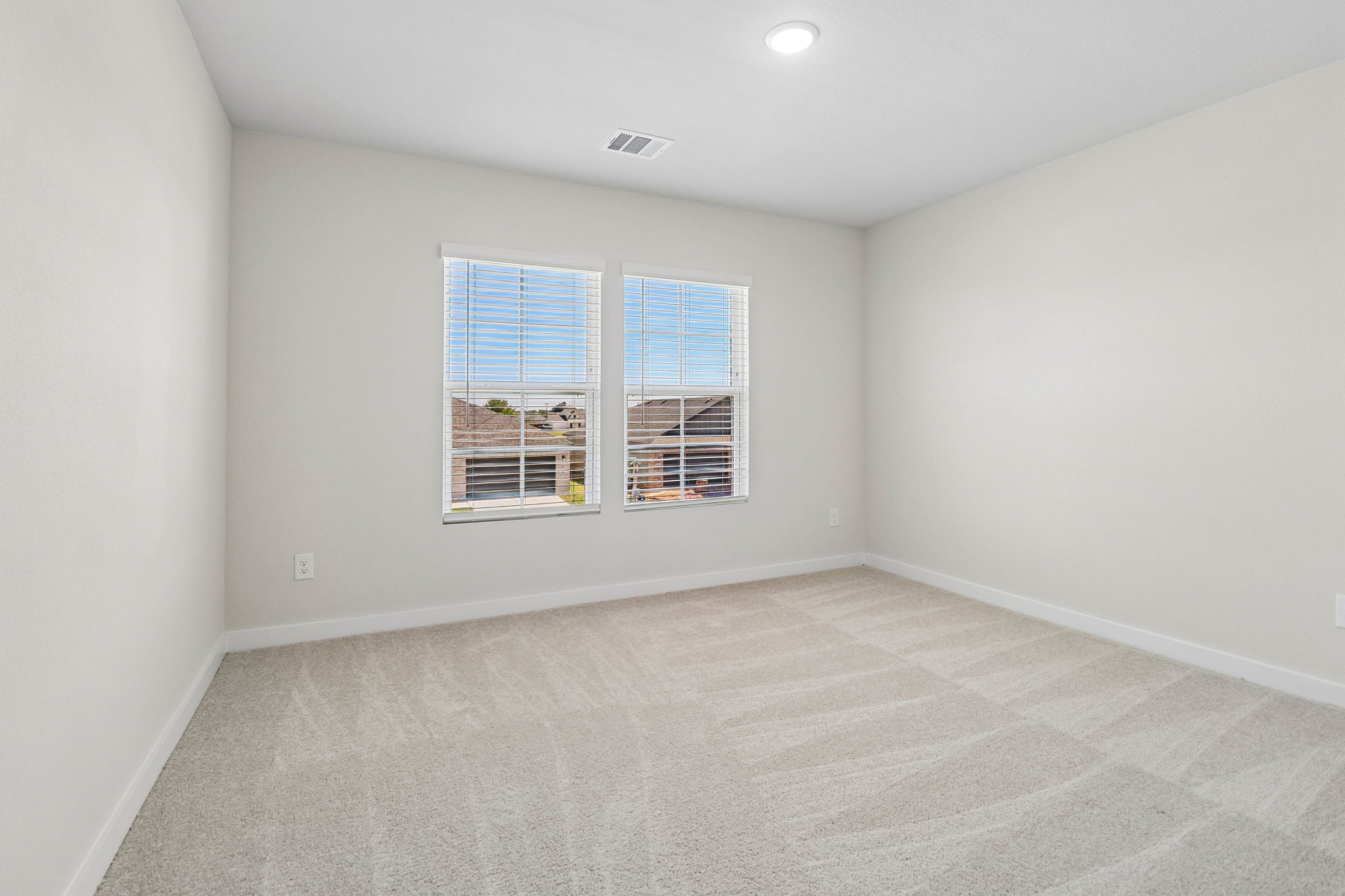A room with a window and a carpet.