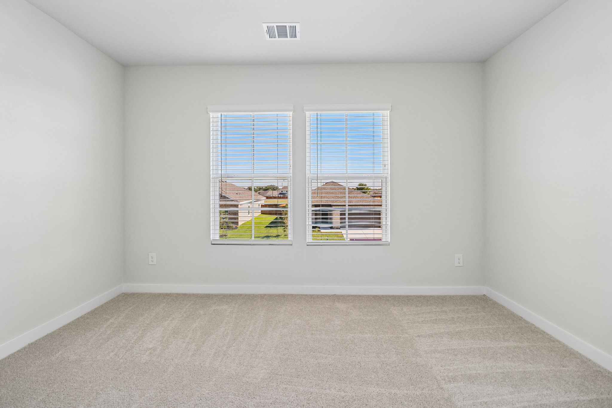 A room with a window and a carpet.