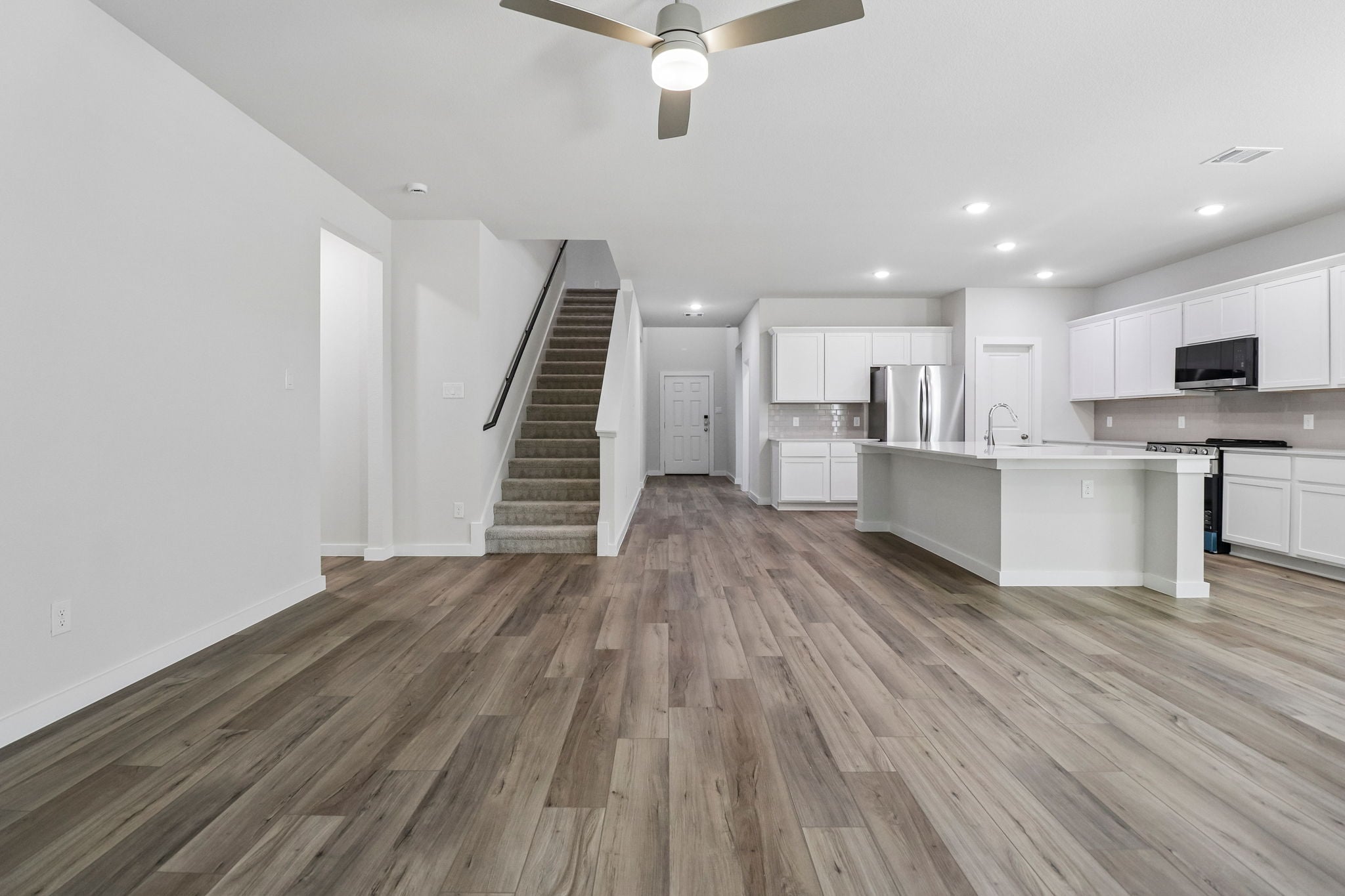A large kitchen with white cabinets.