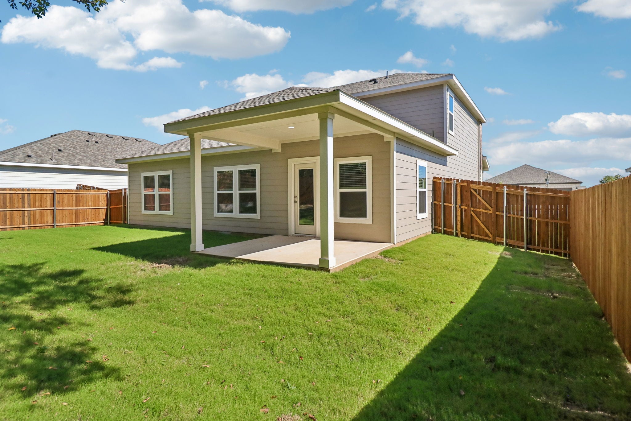A house with a fence and grass.
