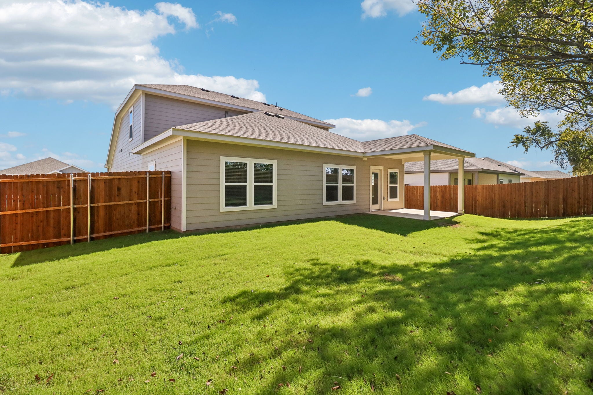 A house with a fence and grass.