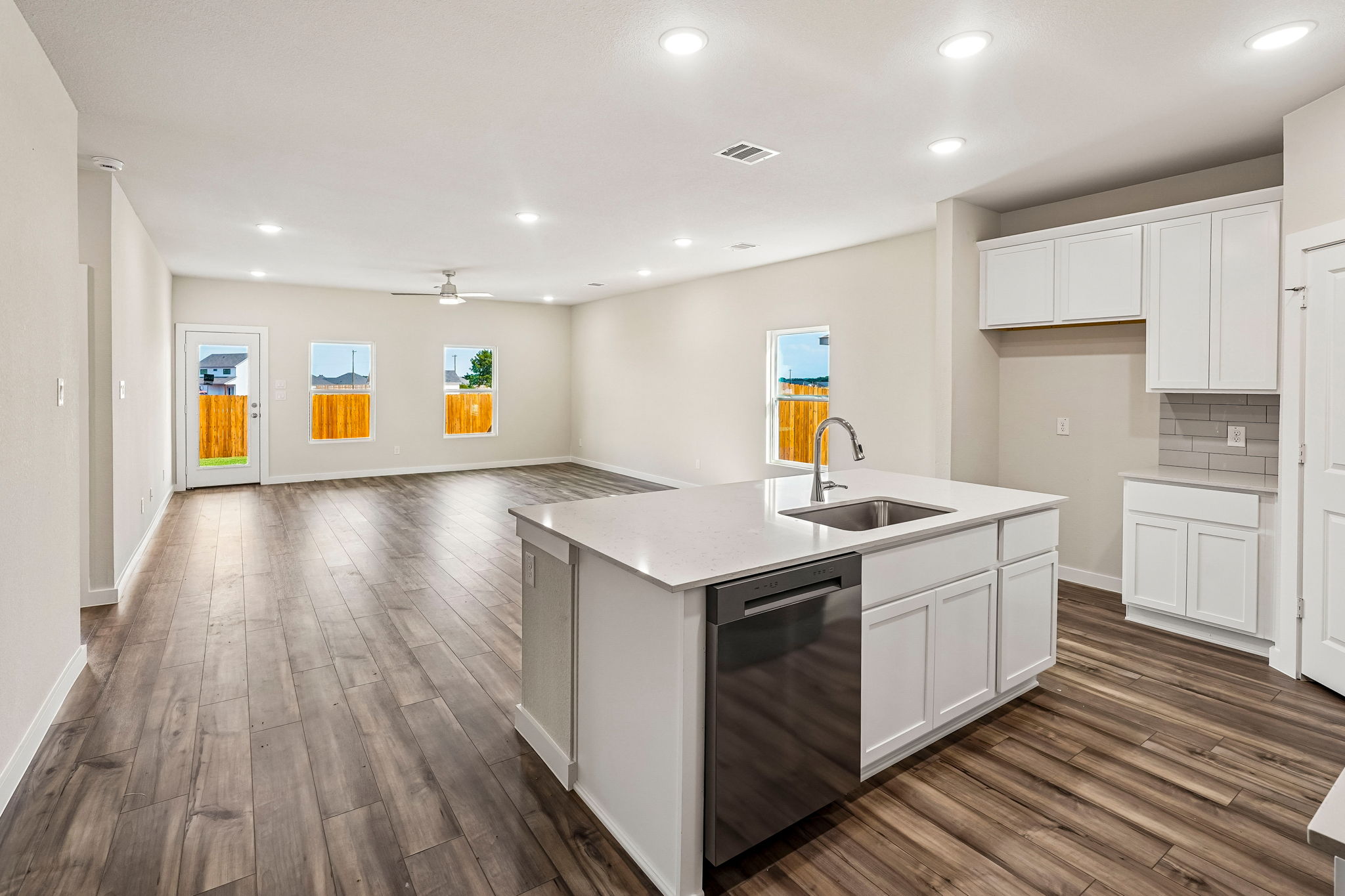 A kitchen with white cabinets.