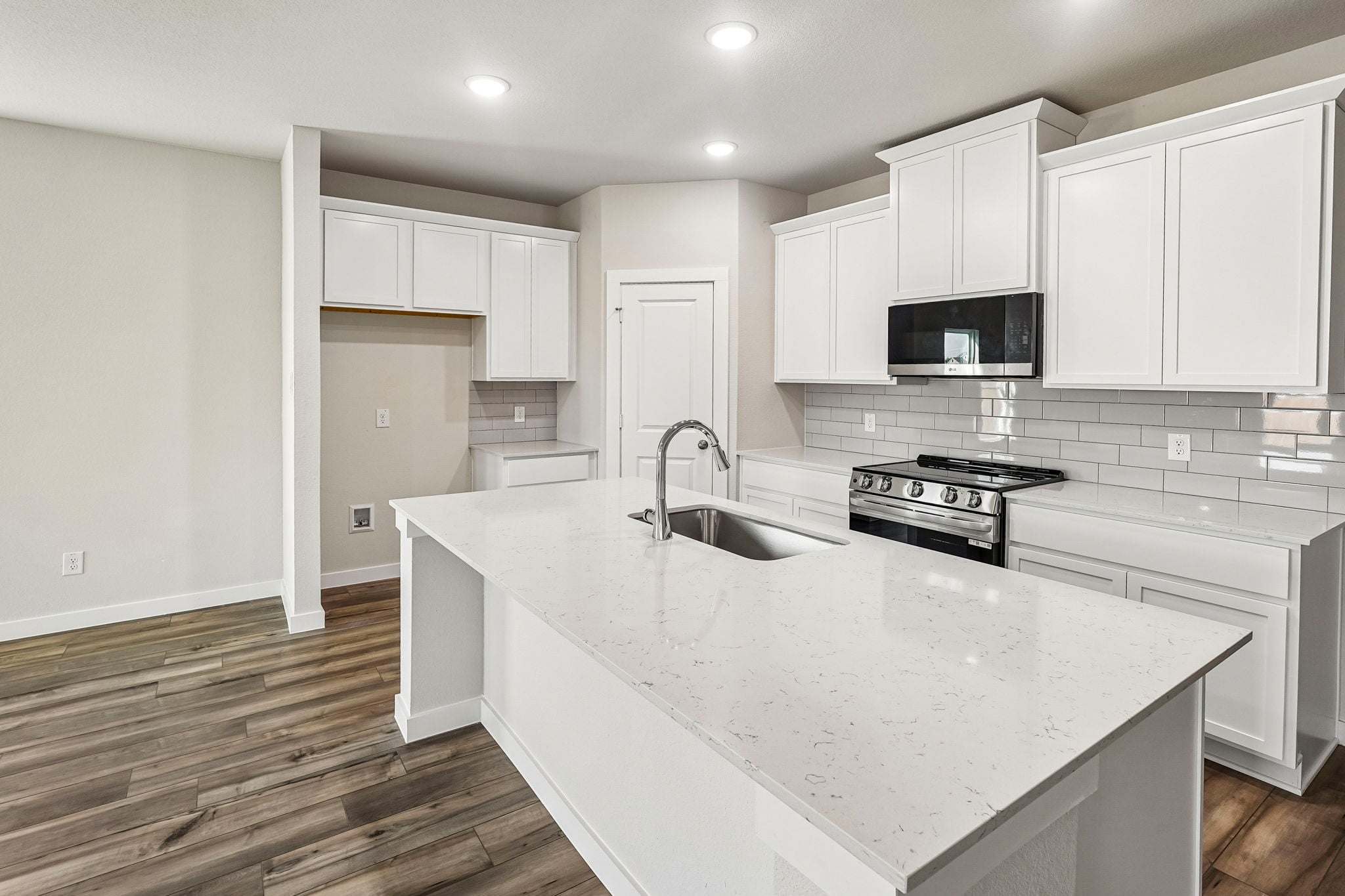 A kitchen with white cabinets.