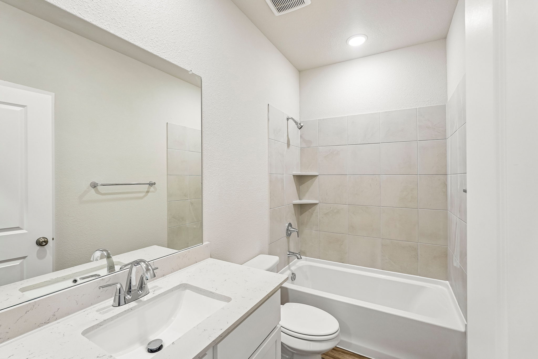 A bathroom with a tub sink and toilet.